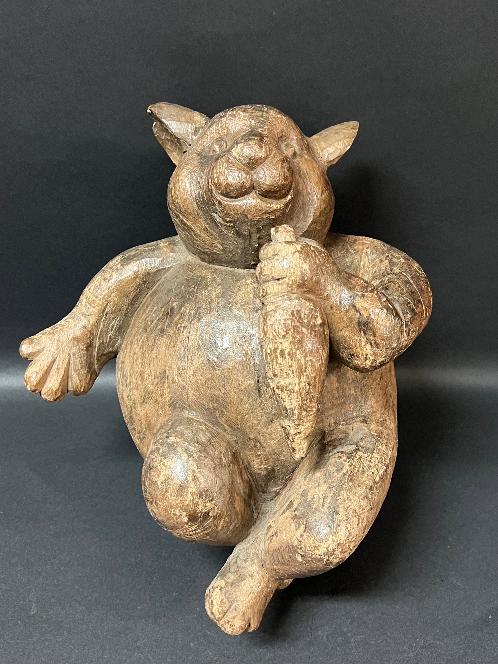 Hand Carved Wooden Rabbit Holding Carrot Sculpture: Folk Art Hand Carved Wooden Rabbit Holding Carrot Sculpture. The dimension is 13 inches high x 9.5 inches wide. Please be aware that some of the items are vintage, secondhand, old ages, antiques and m