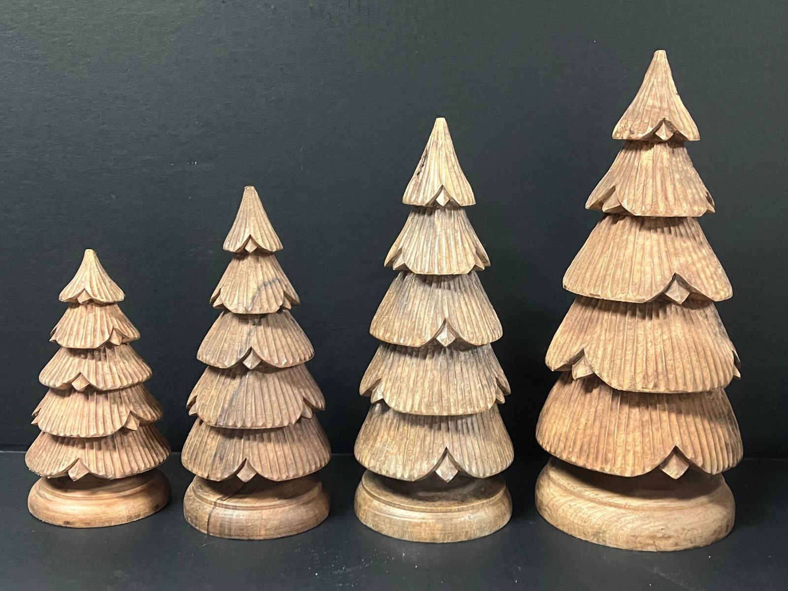 Set of 4 Hand Carved Wooden Christmas Tree Sculpture: Set of 4 Folk Art Hand Carved Wooden Christmas Tree Sculpture. The dimension is 14.25 x 6, 12.5 x 5, 10.25 x 4.5 and 8.25 x 4.5 inches high x inches wide. Please be aware that some of the items are vi