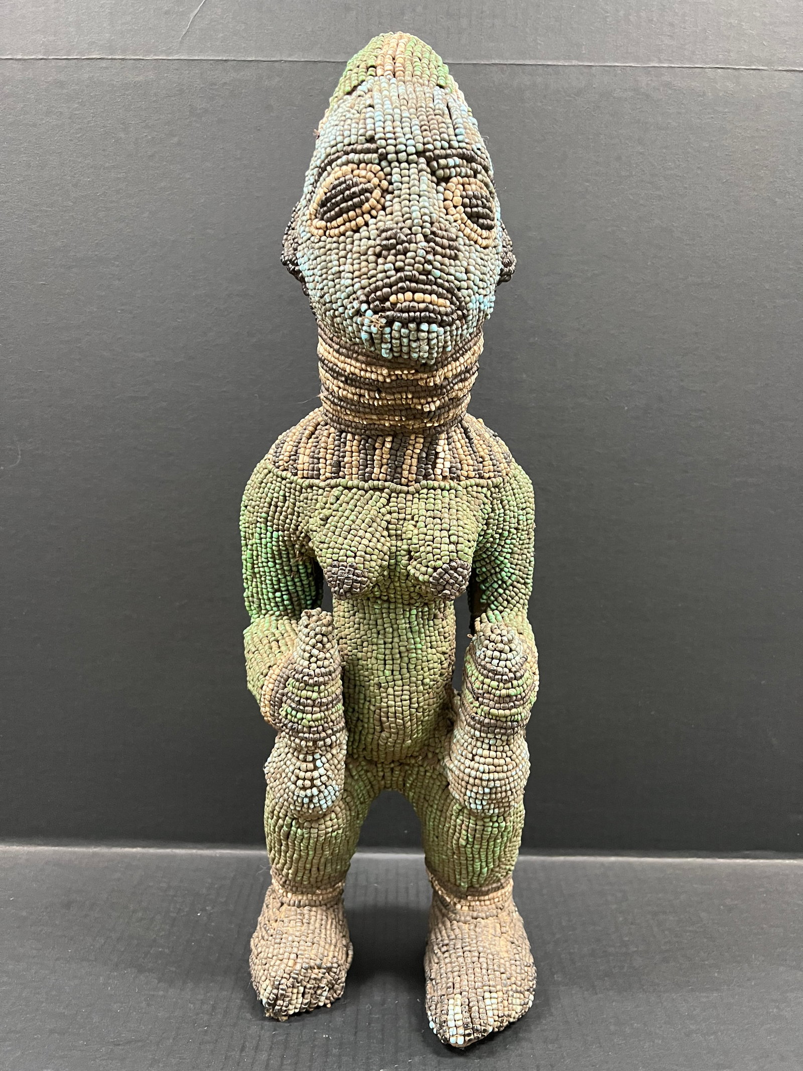Bamileke Beaded Statue: African Tribal Art Bamileke Beaded Statue. The dimension is 23 inches high x 7.5 inches wide. Please be aware that some of the items are vintage, secondhand, old ages, antiques and may have a defects