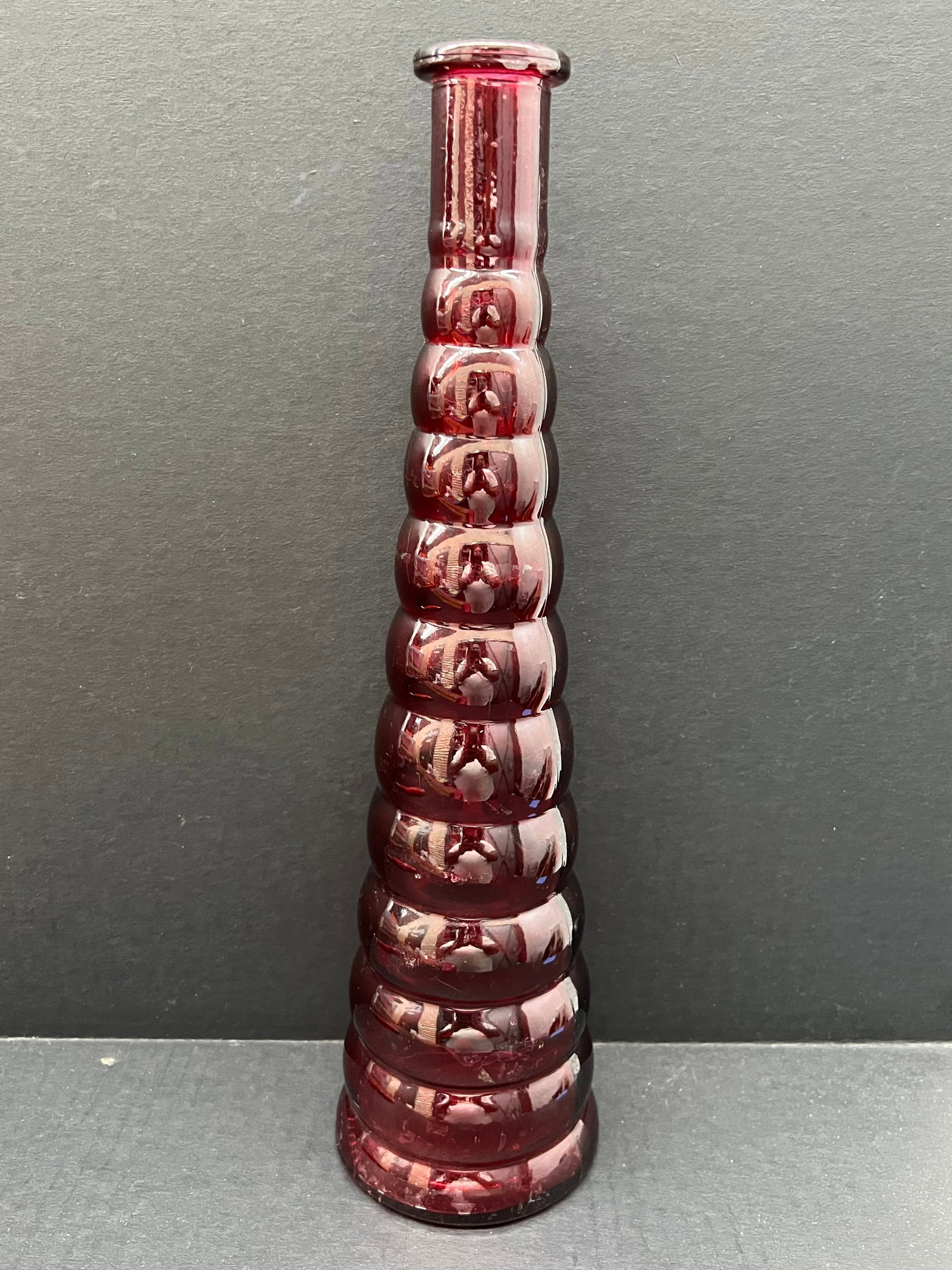 Red Cold Art Glass Flower Vase: Vintage Art Glass Red Color Flower Vase. The dimension is 14 inches high x 4 inches wide. Please be aware that some of the items are vintage, secondhand, old ages, antiques and may have a defects or