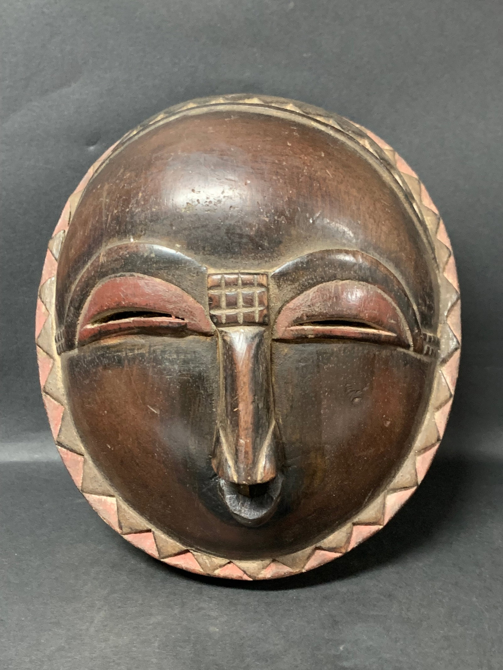 African Tribal Art Carved Wood Baule Mask: African Tribal Art Carved Wood Baule Mask. The dimension is 9.5 inches high x 8.5 inches wide. Please be aware that some of the items are vintage, secondhand, old ages, antiques and may have a defects