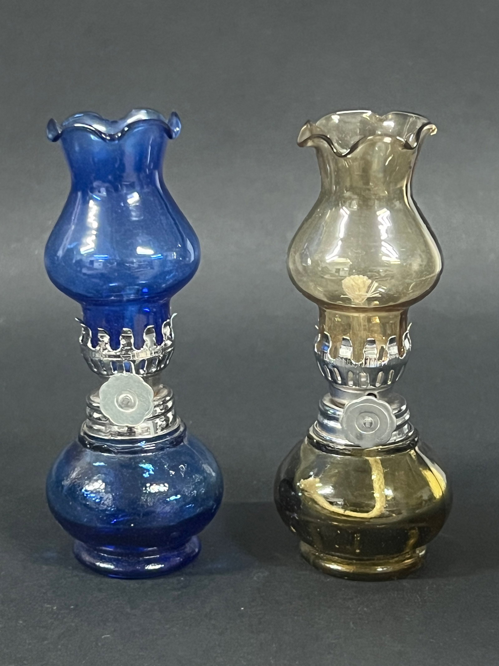 Pair of Glass Small Table Oil Lamp: Pair of Small Glass Table Oil Lamps. The dimension is 4.25 inches high x 1.75 inches wide. Please be aware that some of the items are vintage, secondhand, old ages, antiques and may have a defects or