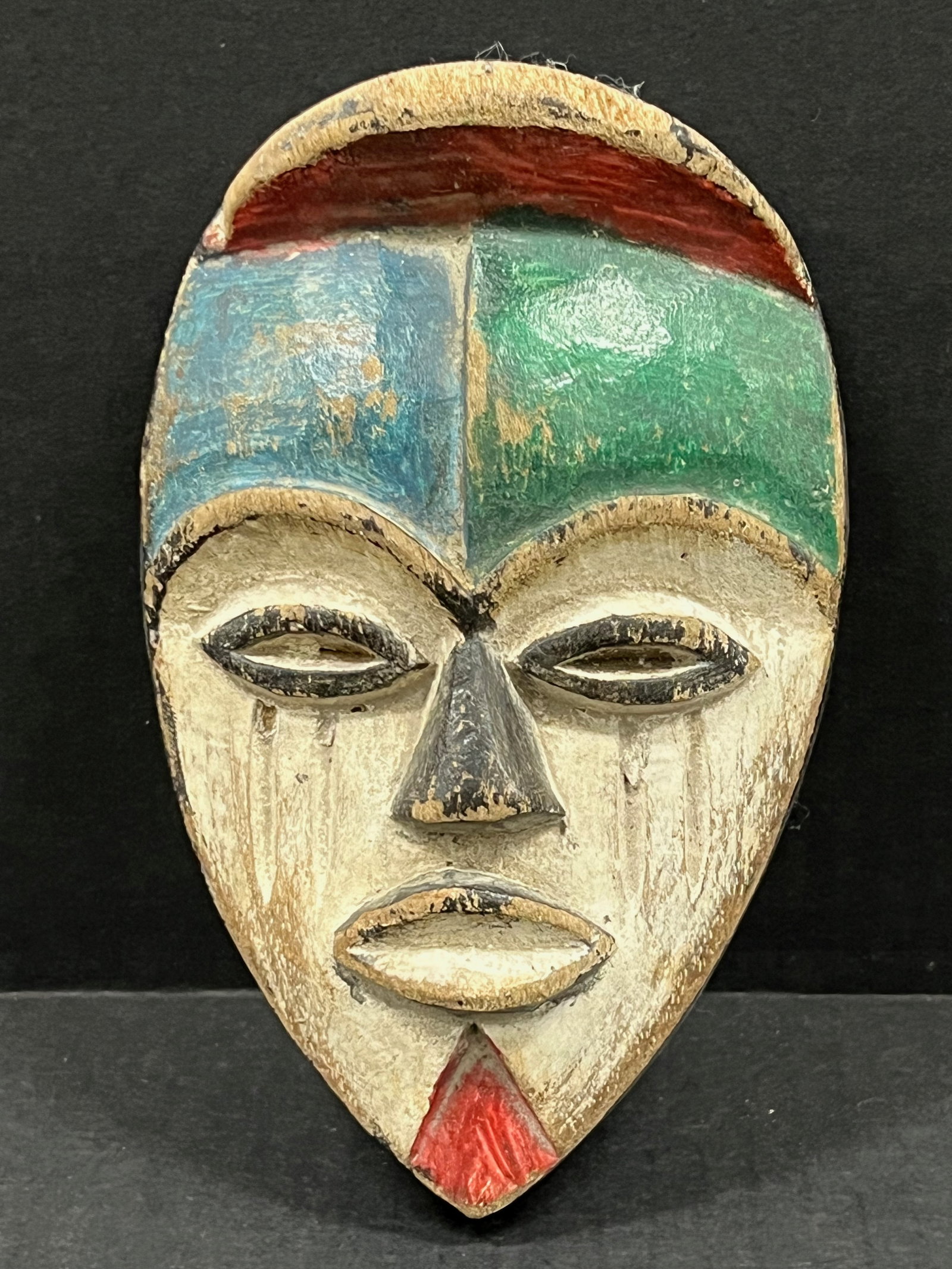 Passport Mask: African Tribal Art Passport Mask. The dimension is 6.75 inches high x 4.25 inches wide. Please be aware that some of the items are vintage, secondhand, old ages, antiques and may have a defects or sig