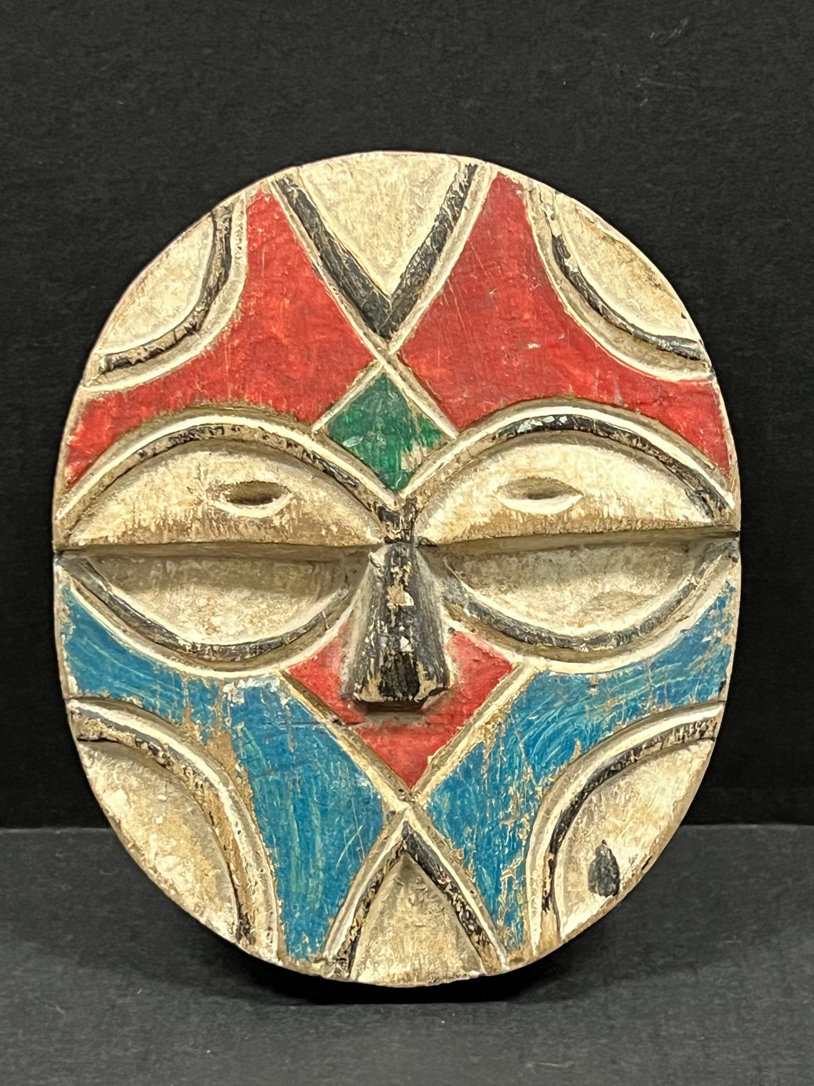 Passport Mask: African Tribal Art Passport Mask. The dimension is 5.75 inches high x 4.75 inches wide. Please be aware that some of the items are vintage, secondhand, old ages, antiques and may have a defects or sig