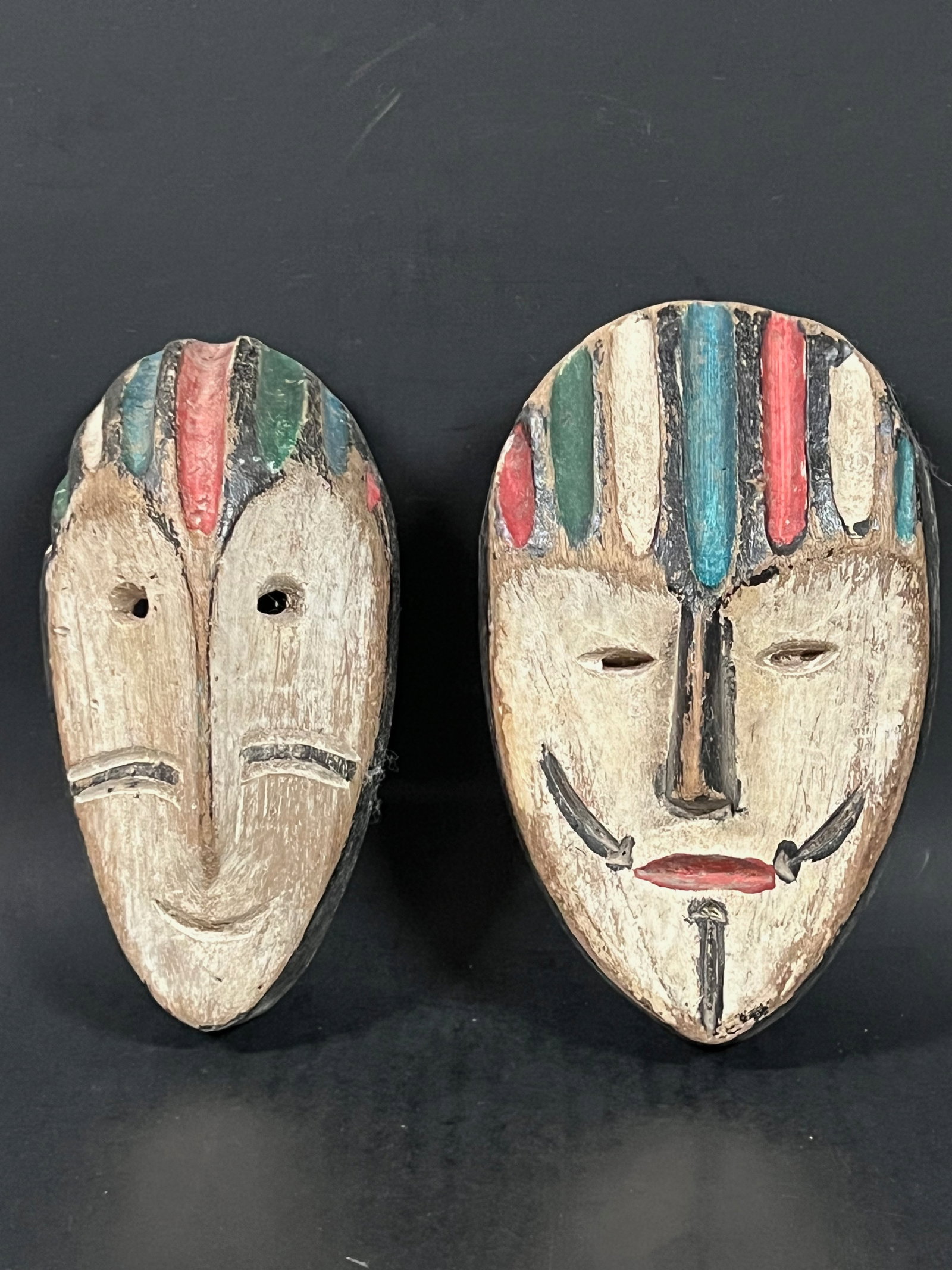 Passport Mask 2 pieces: African Tribal Art Passport Mask. The dimension is 6.5 inches high x 4 inches wide and 6.25 inches high x 3.25 inches wide. Please be aware that some of the items are vintage, secondhand, old ages, an