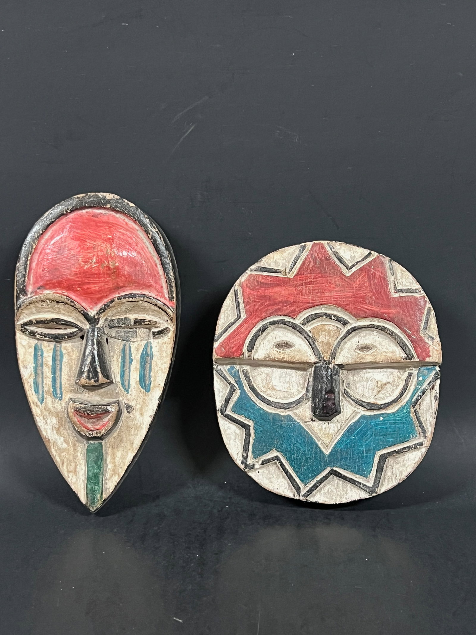 Passport Mask 2 pieces: African Tribal Art Passport Mask. The dimension is 6.75 inches high x 3.75 inches wide and 5.5 inches high x 5 inches wide. Please be aware that some of the items are vintage, secondhand, old ages, an