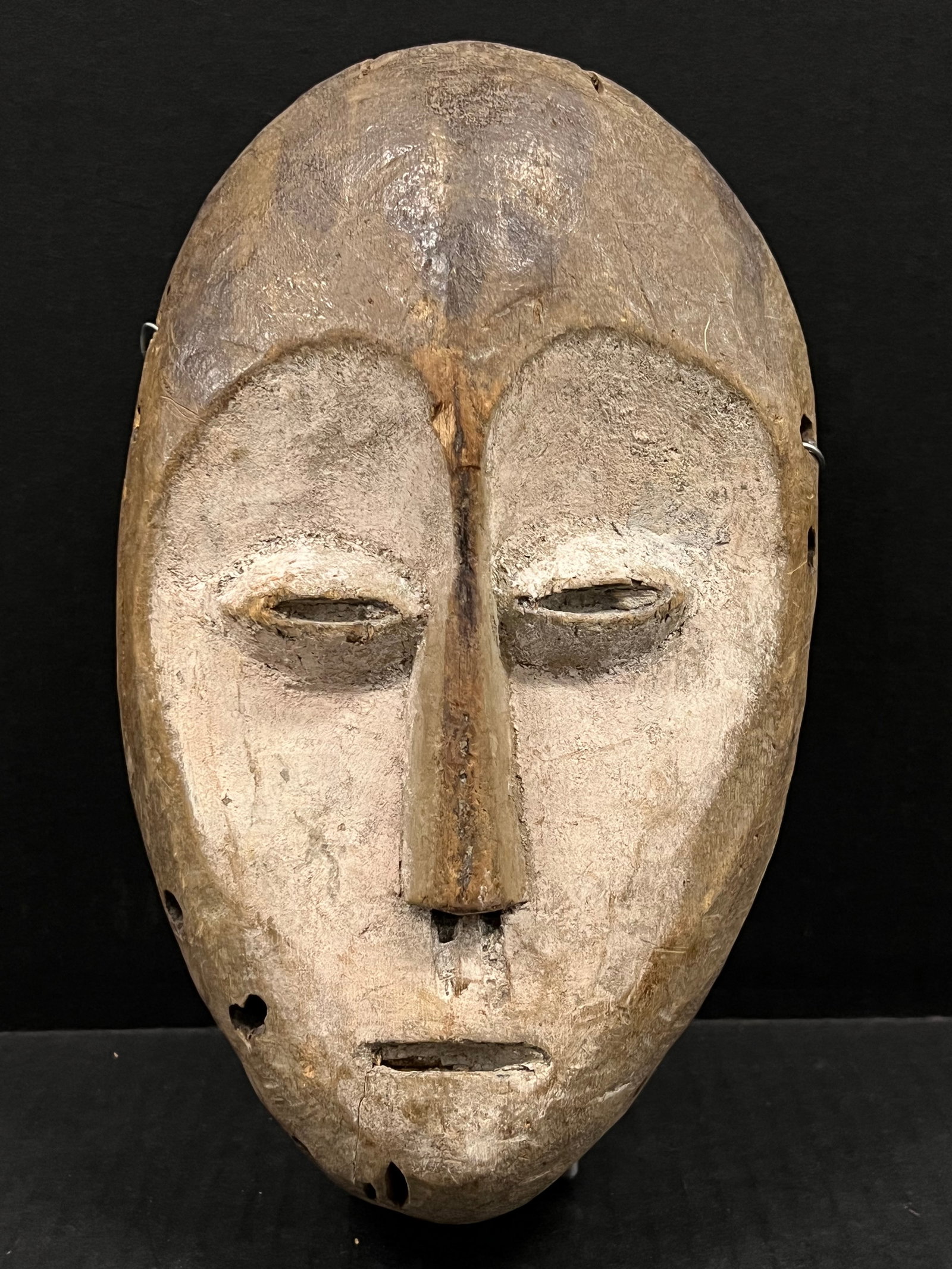 Lega Mask: African Tribal Art Lega Mask. The dimension is 9.75 inches high x 5.75 inches wide. Please be aware that some of the items are vintage, secondhand, old ages, antiques and may have a defects or sign