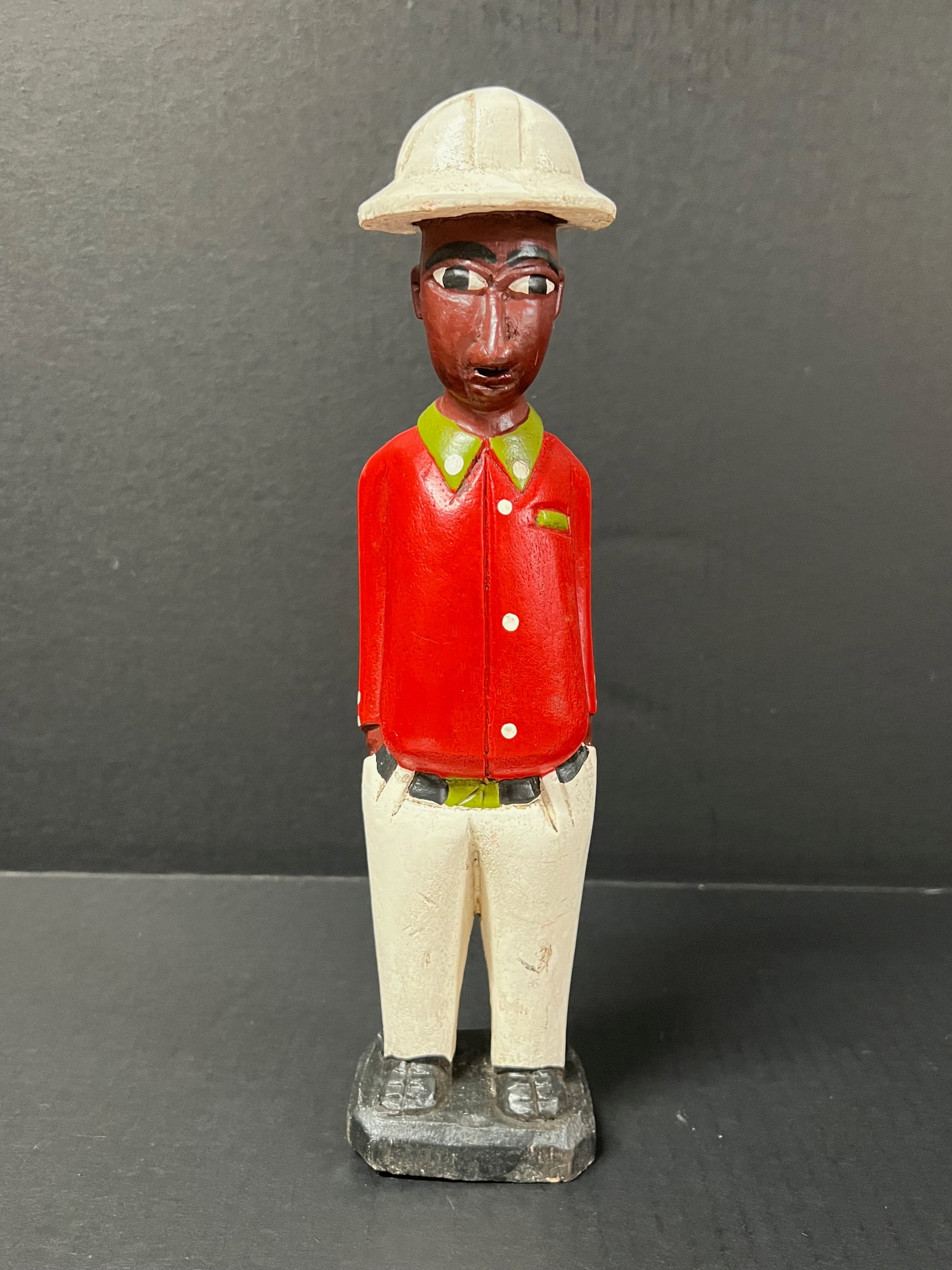 Colonial Statue: African Tribal Art Colonial Statue. The dimension is 12 inches high x 2.5 inches wide. Please be aware that some of the items are vintage, secondhand, old ages, antiques and may have a defects or sign