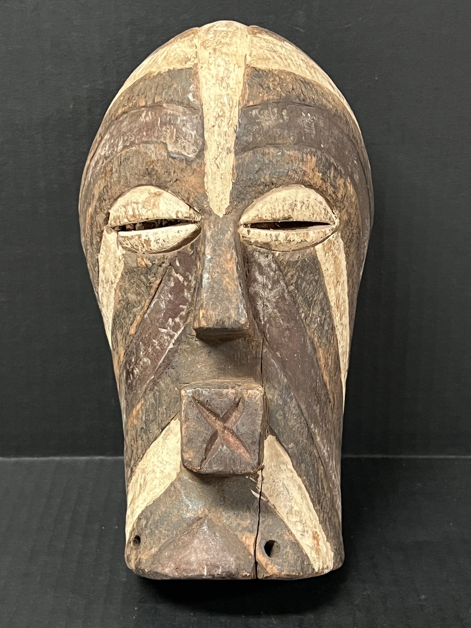 Songye Mask: African Tribal Art Songye Mask. The dimension is 10 inches high x 5.75 inches wide. Please be aware that some of the items are vintage, secondhand, old ages, antiques and may have a defects or sign of