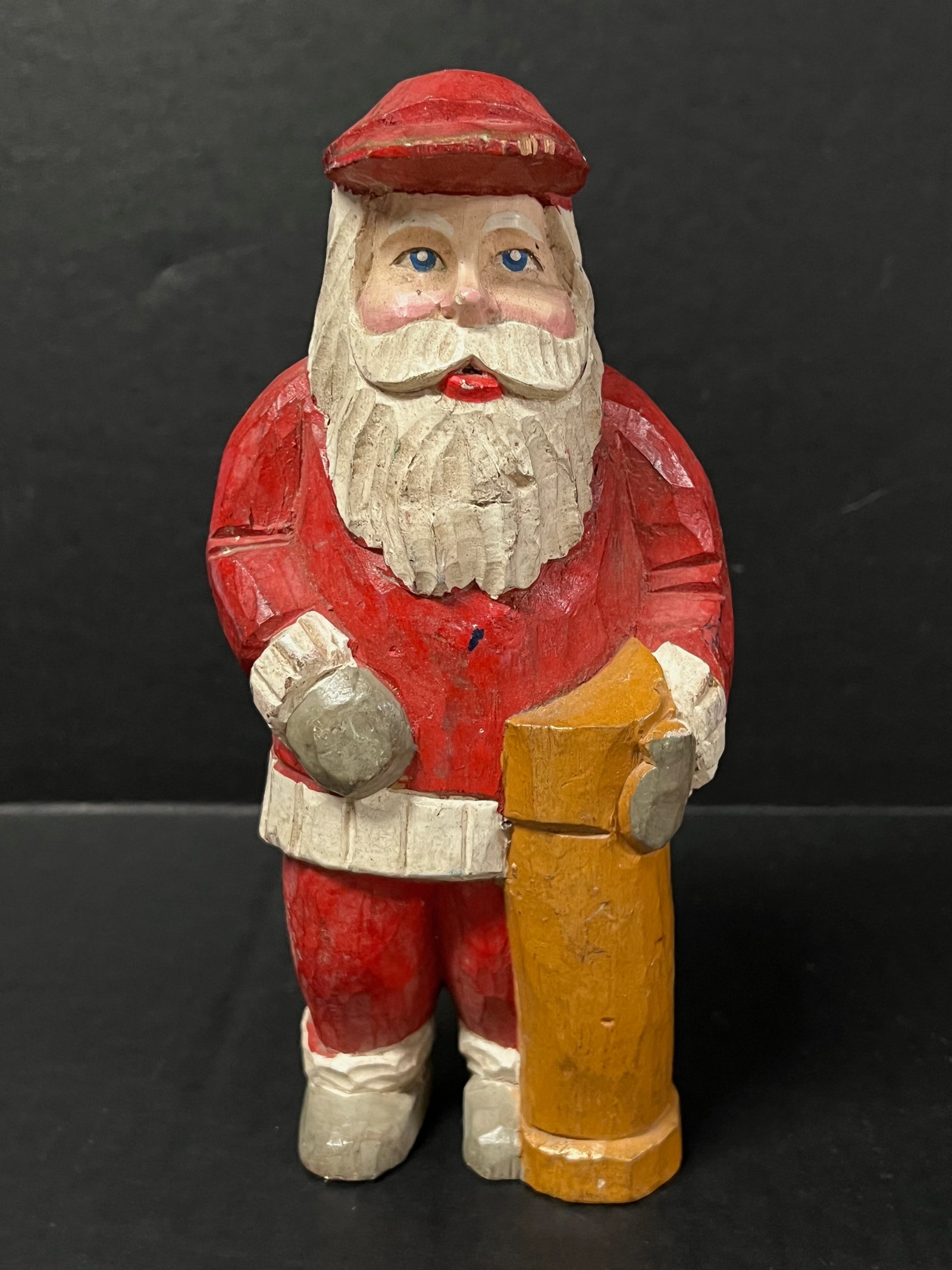Carved Wood Santa Claus: Folk Art Carved Wood Santa Claus. The dimension is 8.25 inches high x 4 inches wide. Please be aware that some of the items are vintage, secondhand, old ages, antiques and may have a defects or sign