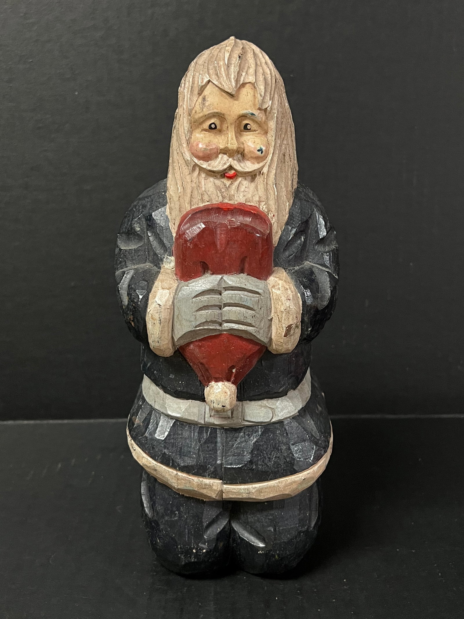 Carved Wood Santa Claus: Folk Art Carved Wood Santa Claus. The dimension is 10.5 inches high x 4 inches wide. Please be aware that some of the items are vintage, secondhand, old ages, antiques and may have a defects or sign