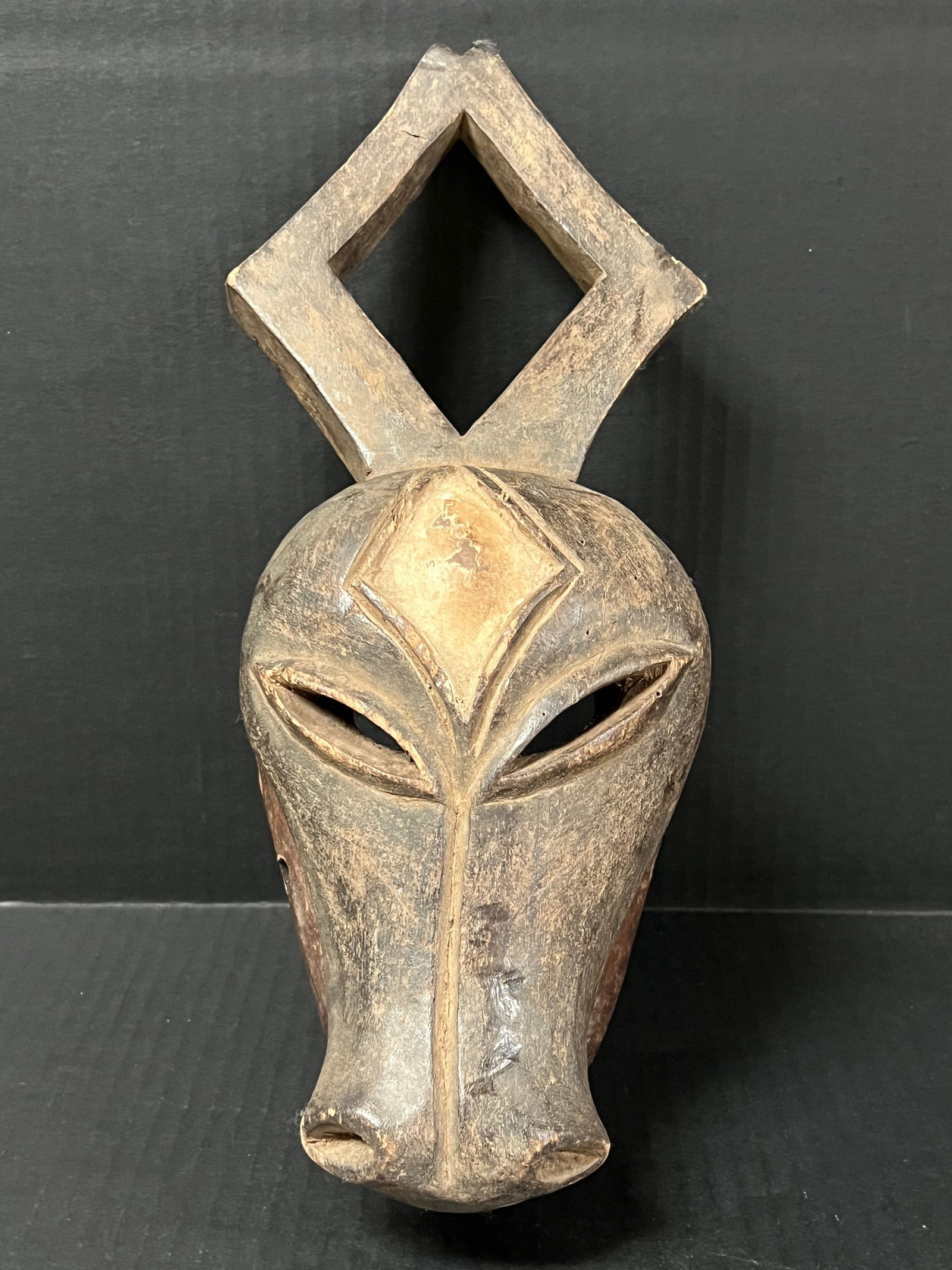 Kwele Mask: African Tribal Art Kwele Mask. The dimension is 13.25 inches high x 5.75 inches wide. Please be aware that some of the items are vintage, secondhand, old ages, antiques and may have a defects or sign 