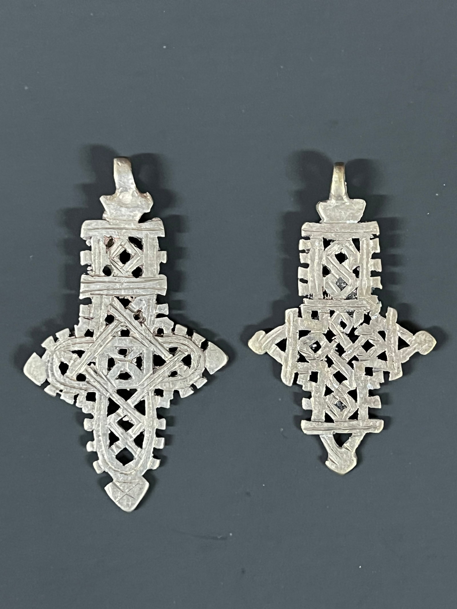 Ethiopian Coptic Cross Pendant 2 pieces: African Tribal Art Ethiopian Coptic Cross Pendant. The dimension is 3.5 inches high x 2 inches wide and 3 inches high x 2 inches wide. Please be aware that some of the items are vintage, secondhand, o