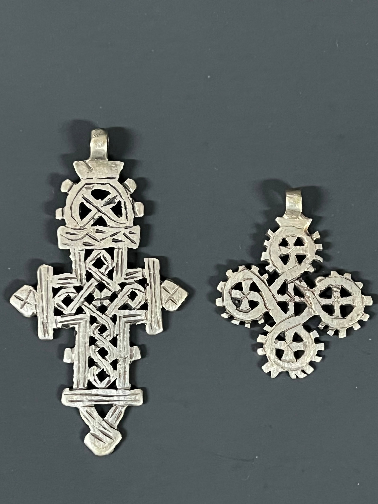Ethiopian Coptic Cross Pendant 2 pieces: African Tribal Art Ethiopian Coptic Cross Pendant. The dimension is 2.5 inches high x 2 inches wide and 4 inches high x 2.5 inches wide. Please be aware that some of the items are vintage, secondhand,