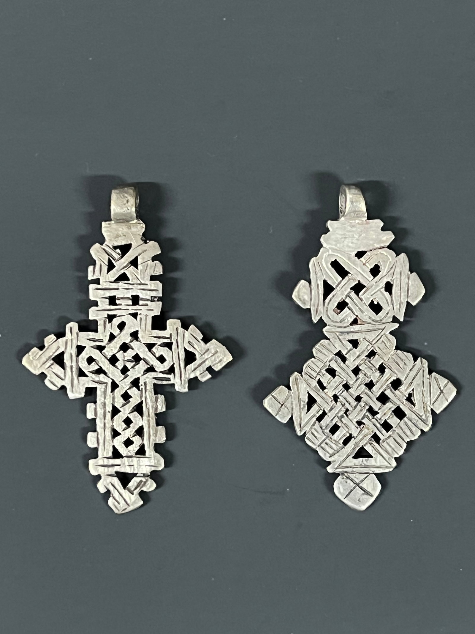 Ethiopian Coptic Cross Pendant 2 pieces: African Tribal Art Ethiopian Coptic Cross Pendant. The dimension is 3.25 inches high x 2 inches wide and 3.25 inches high x 2 inches wide. Please be aware that some of the items are vintage, secondhan