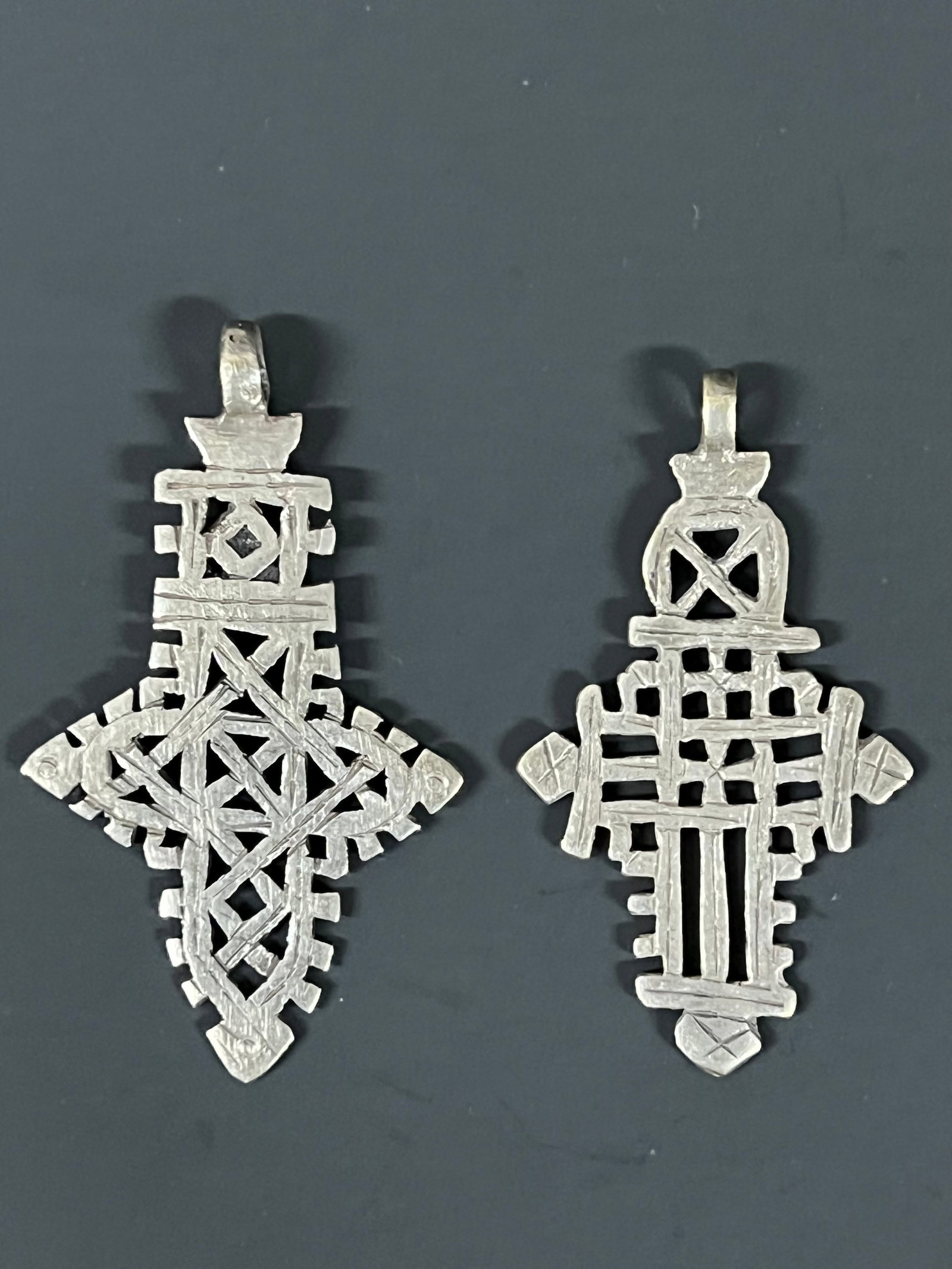 Ethiopian Coptic Cross Pendant 2 pieces: African Tribal Art Ethiopian Coptic Cross Pendant. The dimension is 3.25 inches high x 2 inches wide and 3 inches high x 1.75 inches wide. Please be aware that some of the items are vintage, secondhan