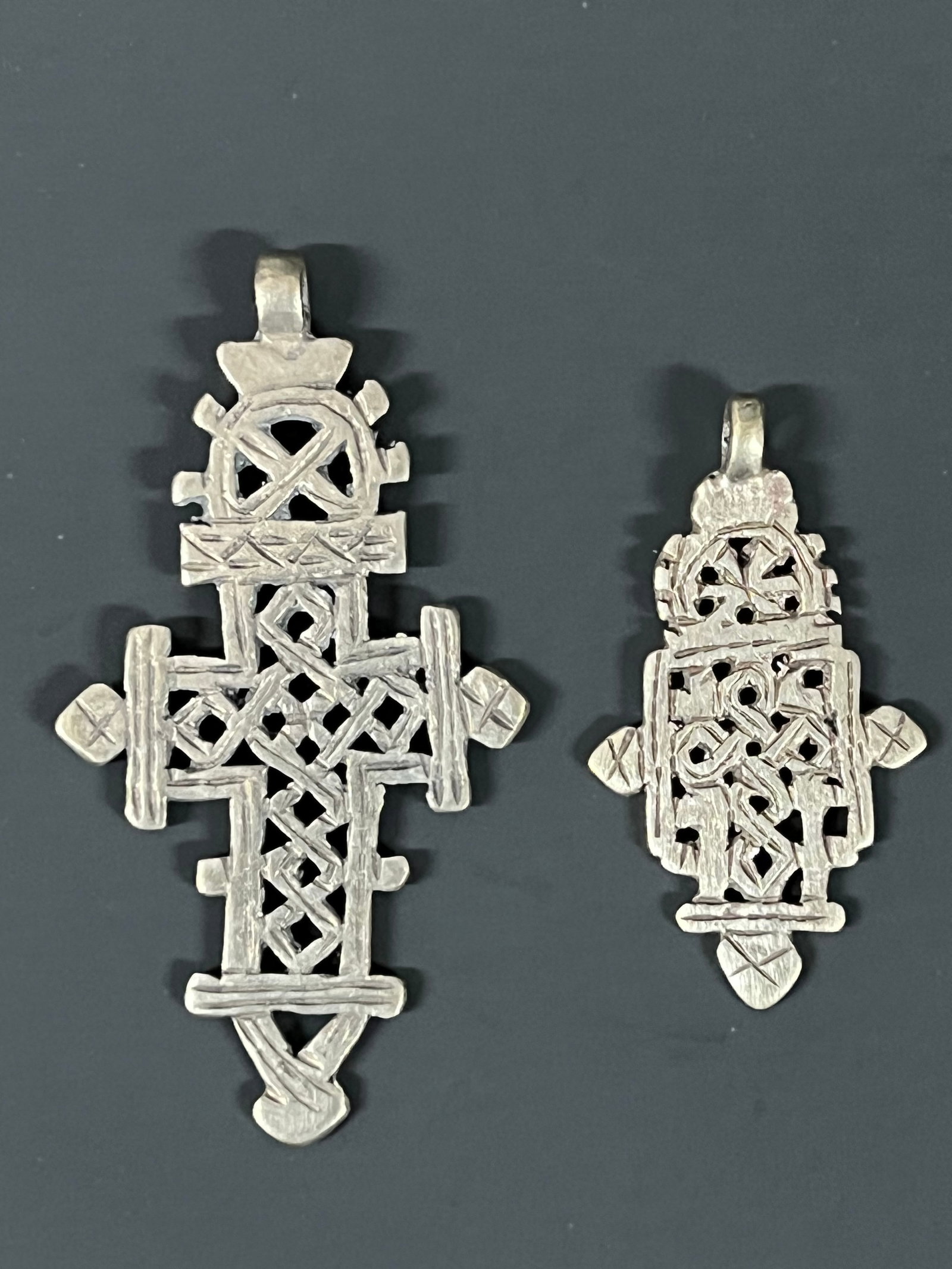 Ethiopian Coptic Cross Pendant 2 pieces: African Tribal Art Ethiopian Coptic Cross Pendant. The dimension is 4 inches high x 2.25 inches wide and 2.75 inches high x 1.5 inches wide. Please be aware that some of the items are vintage,
