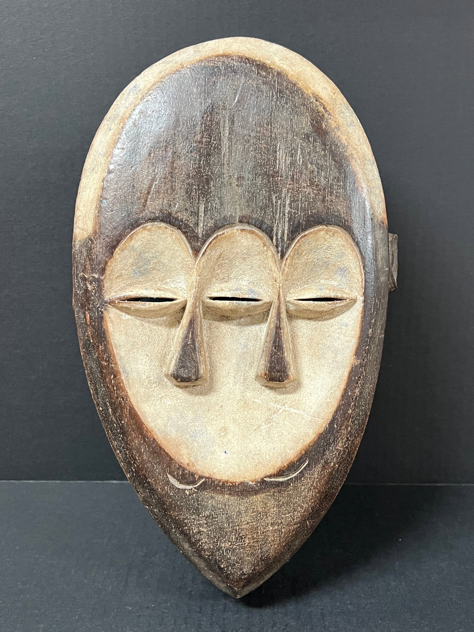 Kwele Mask: African Tribal Art Kwele Mask. The dimension is 15 inches high x 9.5 inches wide. Please be aware that some of the items are vintage, secondhand, old ages, antiques and may have a defects or sign of
