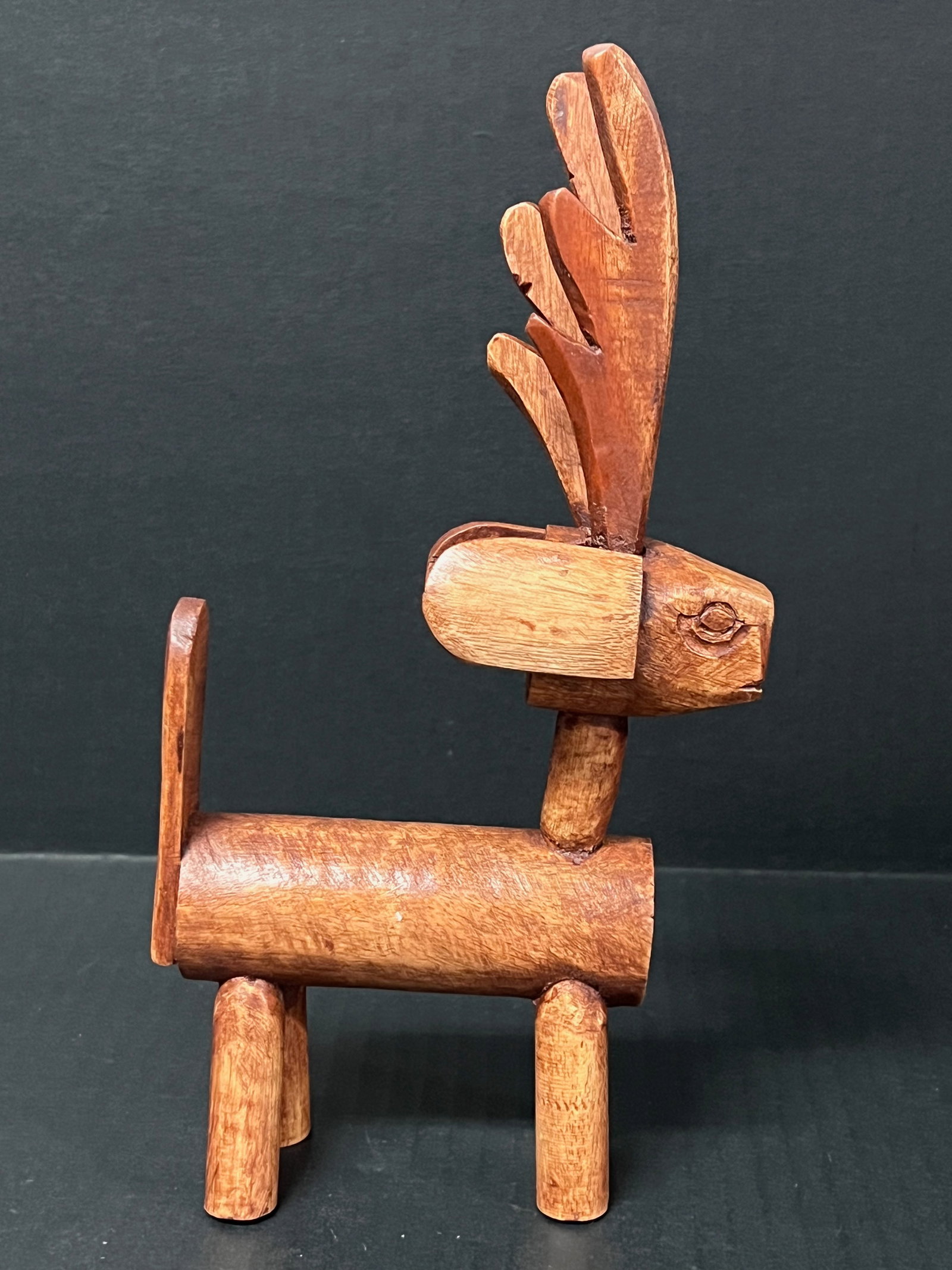 Carved Wood Deer Sculpture: Folk Art Carved Wood Deer Sculpture. The dimension is 10 inches high x 5 inches wide. Please be aware that some of the items are vintage, secondhand, old ages, antiques and may have a defects or sign 