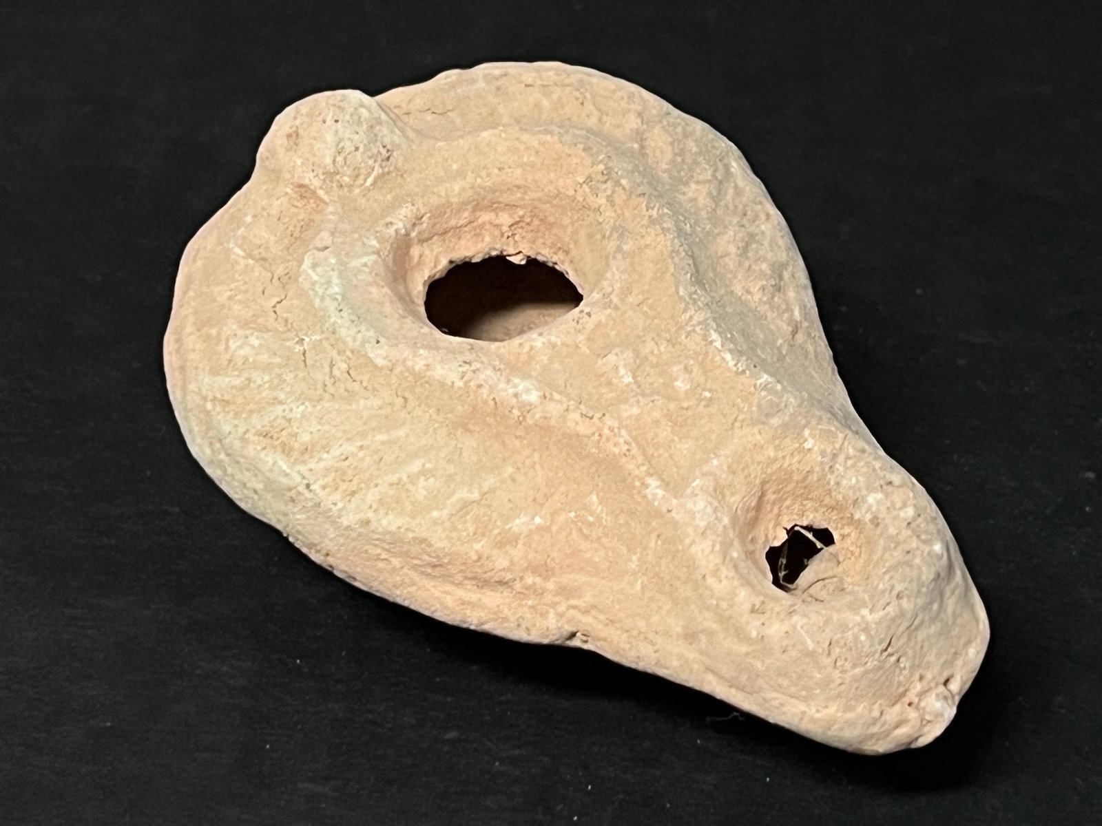 Terre Cotta Oil Lamp: Terra Cotta Oil Lamp. The dimension is 1 inches high x 2 inches wide. Please be aware that some of the items are vintage, secondhand, old ages, antiques and may have a defects or sign of ages,