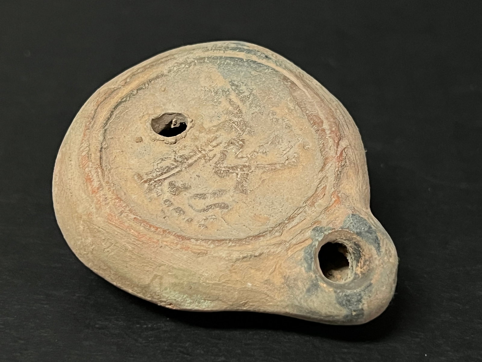 Terre Cotta Oil Lamp: Terra Cotta Oil Lamp. The dimension is 1 inches high x 2 inches wide. Please be aware that some of the items are vintage, secondhand, old ages, antiques and may have a defects or sign of ages, However