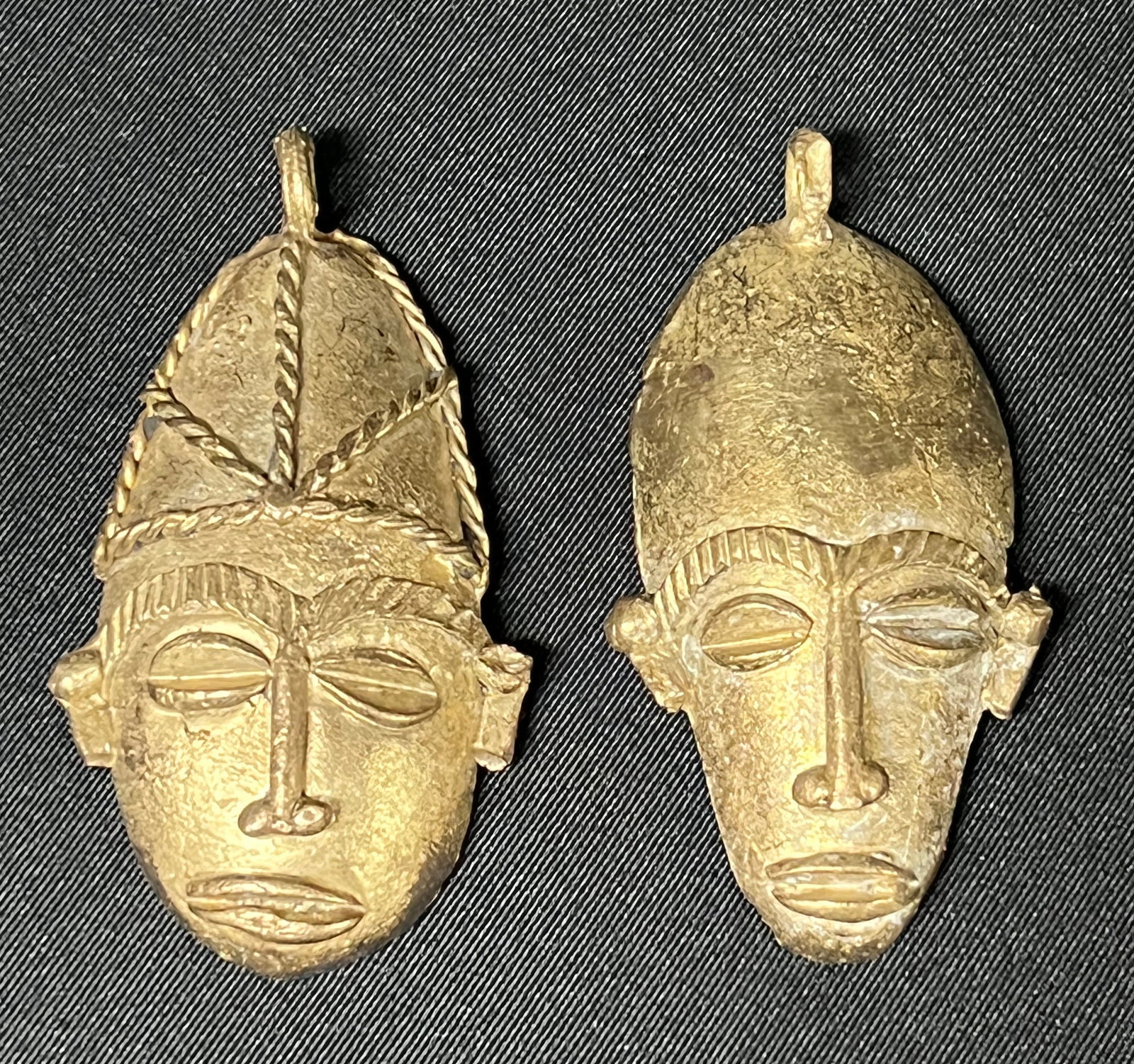 Ashanti Brass Pendant 2 Pieces: African Tribal Brass Pendant 2 Pieces. The dimension is 3 inches high x 3.75 inches wide. Please be aware that some of the items are vintage, secondhand, old ages, antiques and may have a defects or s