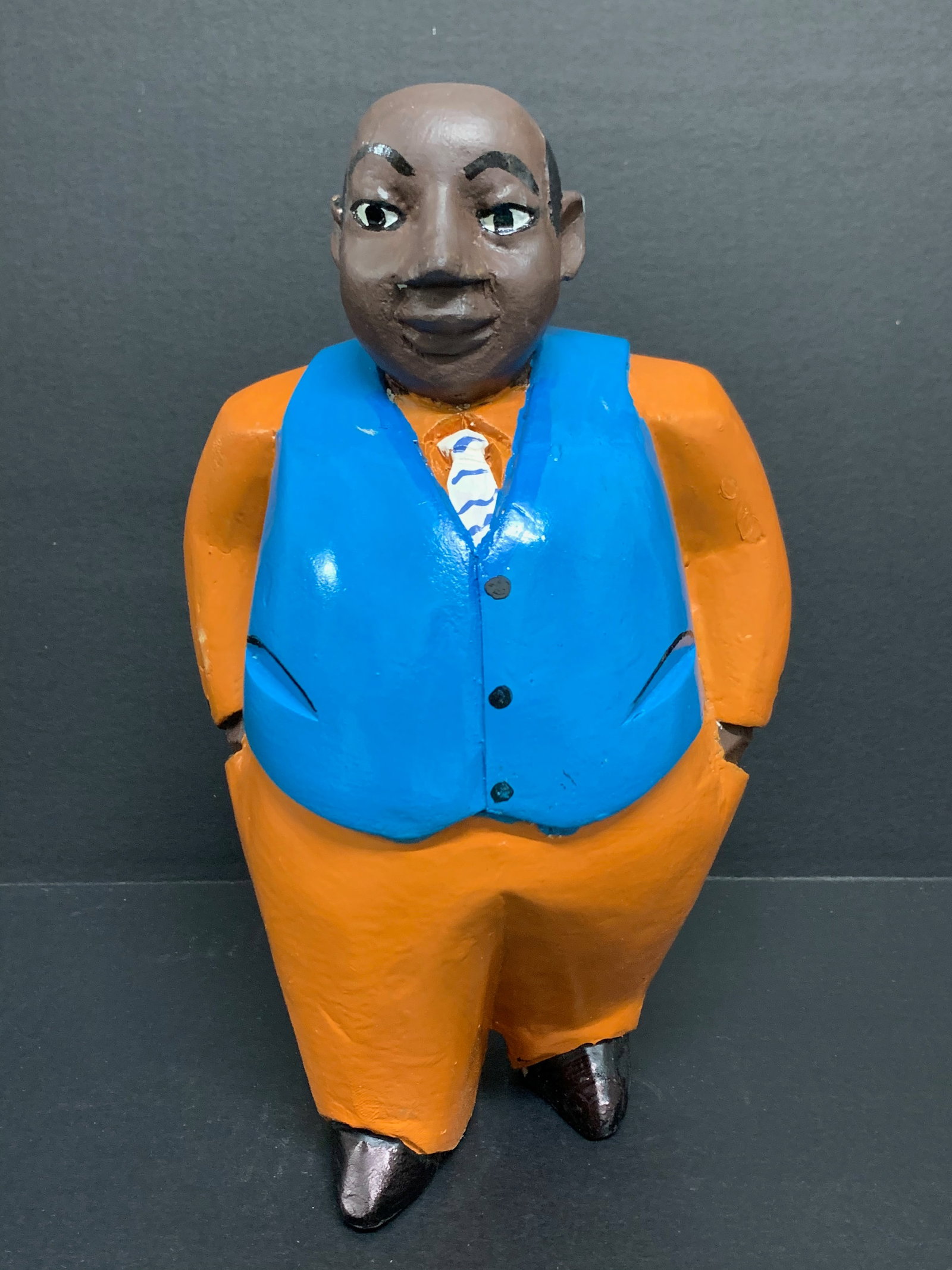 Carved Wood Male Colonial Statue: African Tribal Art Carved Wood Male Colonial Statue. The dimension is 13 inches high x 7 inches wide. Please be aware that some of the items are vintage, secondhand, old ages, antiques and may have a 
