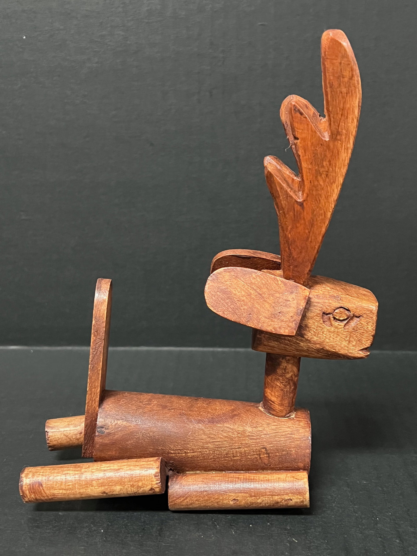 Carved Wood Deer Sculpture: Folk Art Carved Wood Deer Sculpture. The dimension is 8.5 inches high x 6 inches wide. Please be aware that some of the items are vintage, secondhand, old ages, antiques and may have a defects or sign