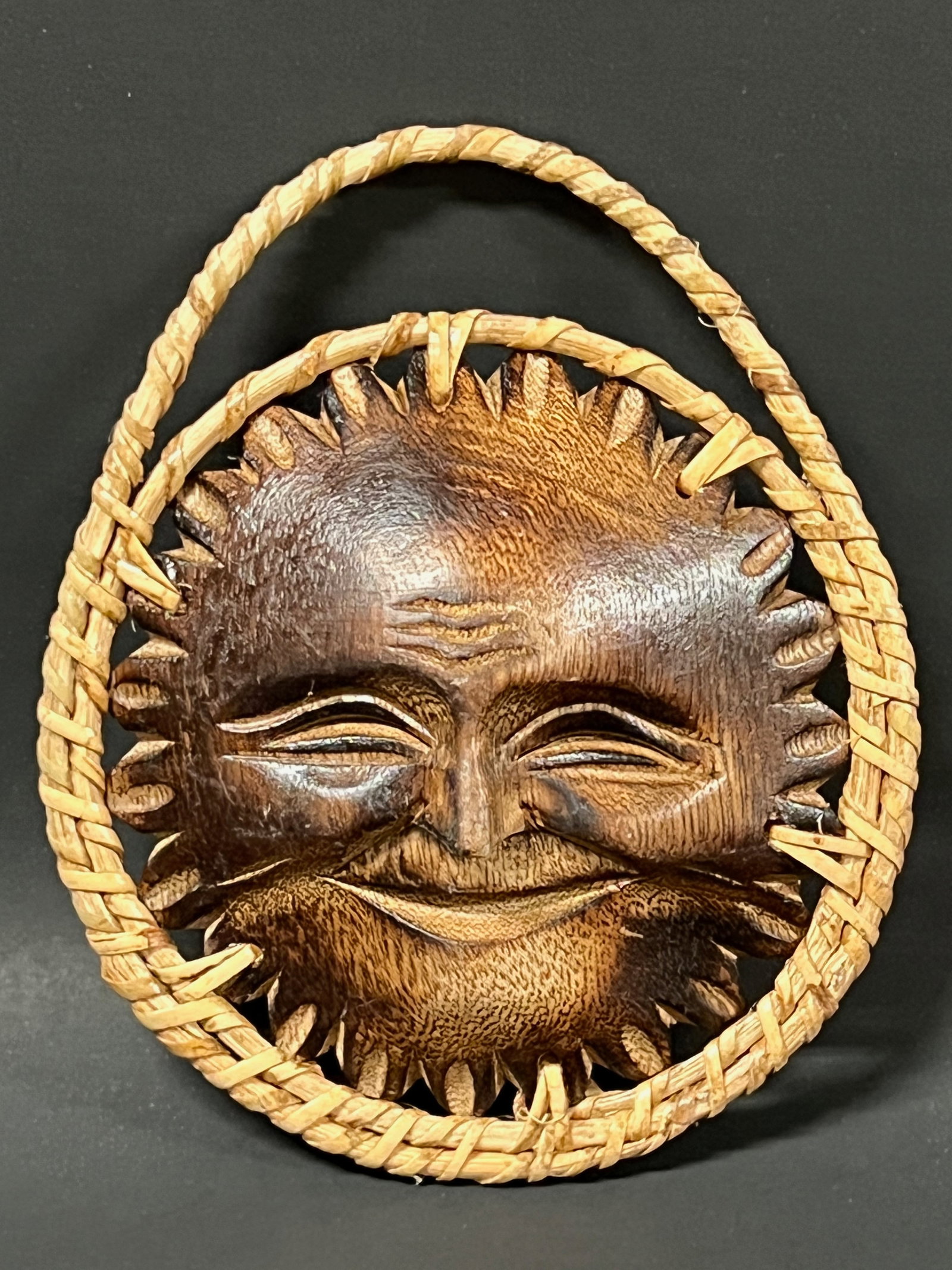 Whimsical Carved Wood Smiling Sun Face Wall Plaque Sculpture: Folk Art Whimsical Carved Wood Smiling Sun Face Wall Sculpture with Woven Rattan Border. The dimension is 5.5 inches high x 4.5 inches wide. Please be aware that some of the items are vintage,