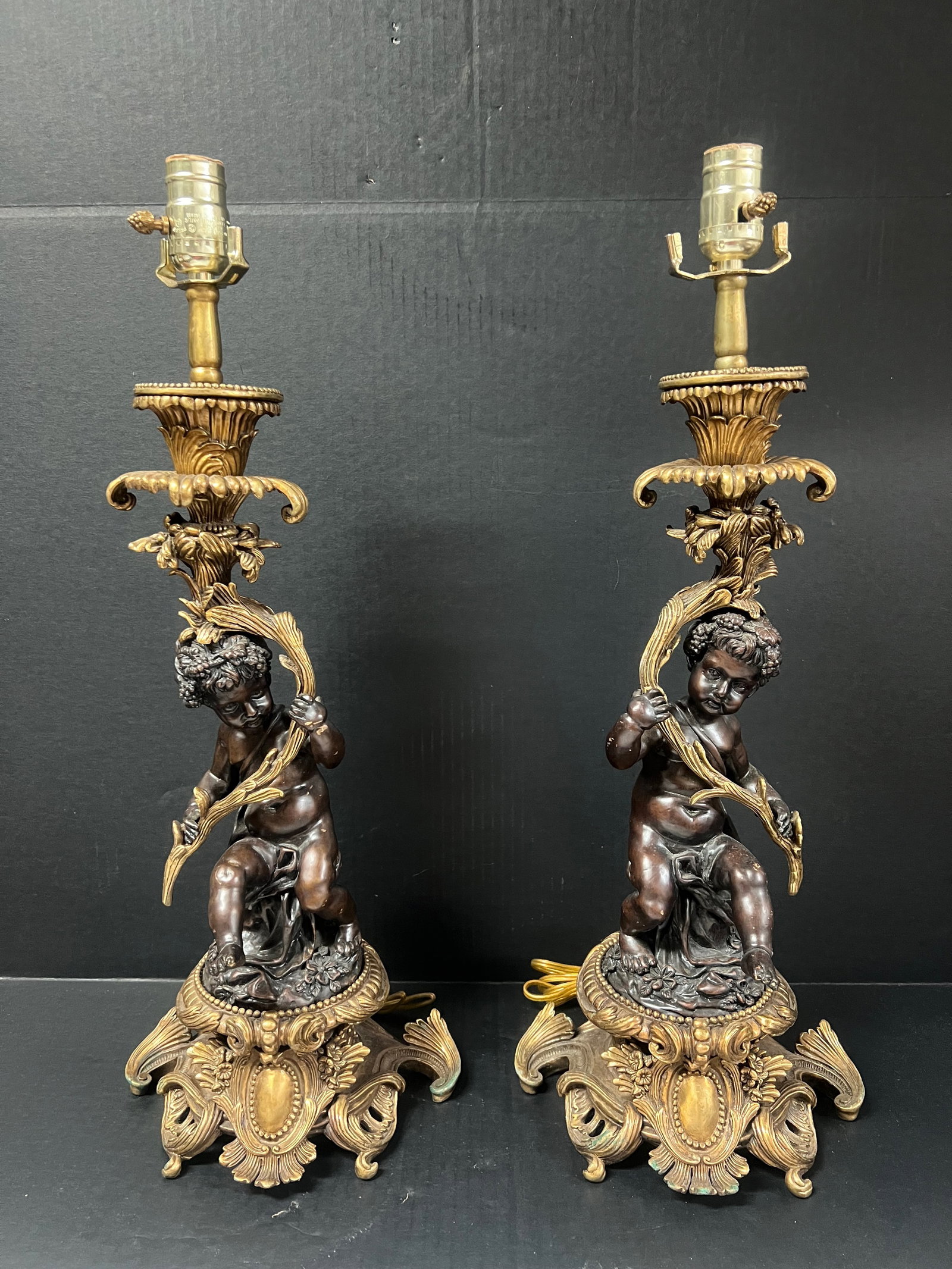 Pair of Vintage European Bronze Cherub Sculpture Table Lamp: Pair of Vintage European Bronze Cherub Sculpture Table Lamp. The dimension is 23.5 inches high x 9 inches wide. Please be aware that some of the items are vintage, secondhand, old ages, antiques and m