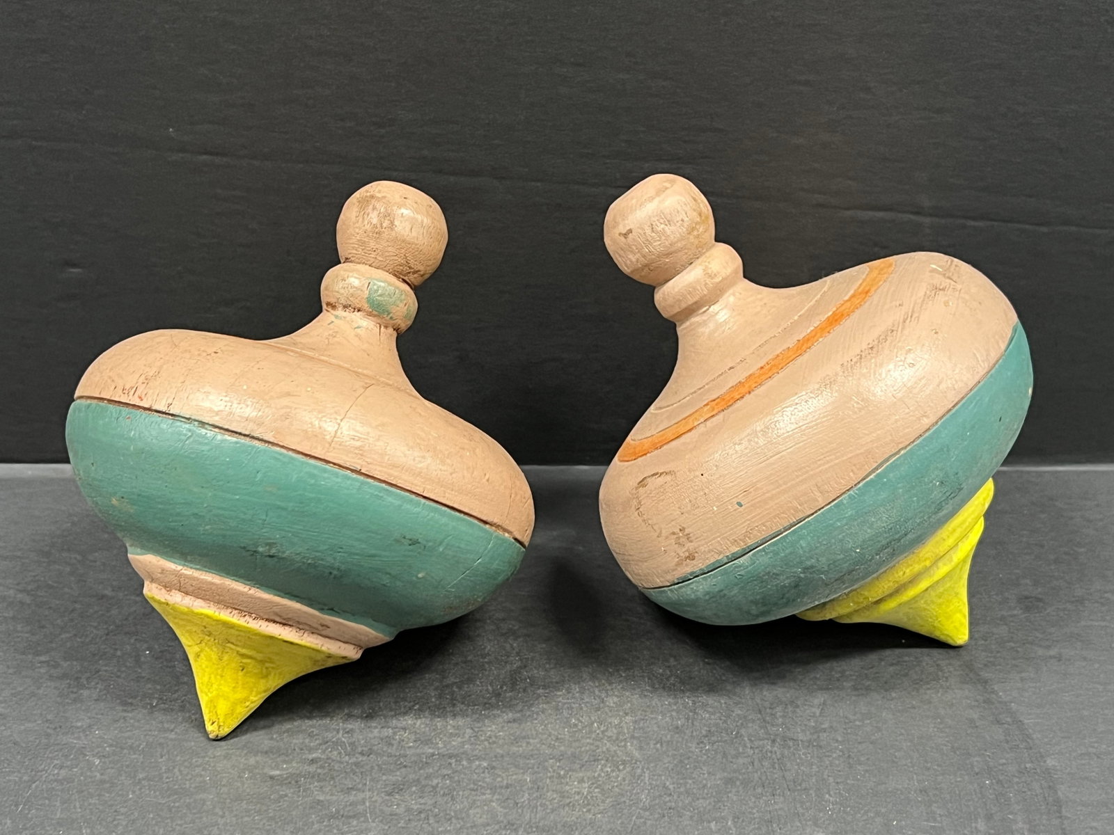 Vintage Hand Carved Wooden Spinning Tops Lot of 2: Vintage Hand Carved Wooden Spinning Tops Lot of 2. The dimension is 6.5 inches high x 5 inches wide. Please be aware that some of the items are vintage, secondhand, old ages, antiques and may have a d