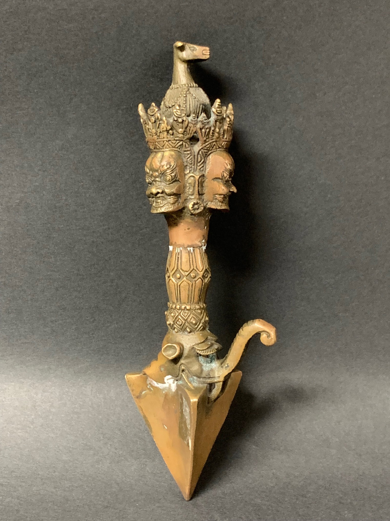 Tibetan Art Gilt Bronze Phurba Ritual Dagger Makura and Garuda Topper: Tibetan Art Gilt Bronze Phurba Ritual Dagger Makura and Garuda Topper. The dimension is 7.5 inches high x 2.75 inches . Please be aware that some of the items are vintage, secondhand, old ages, antiqu