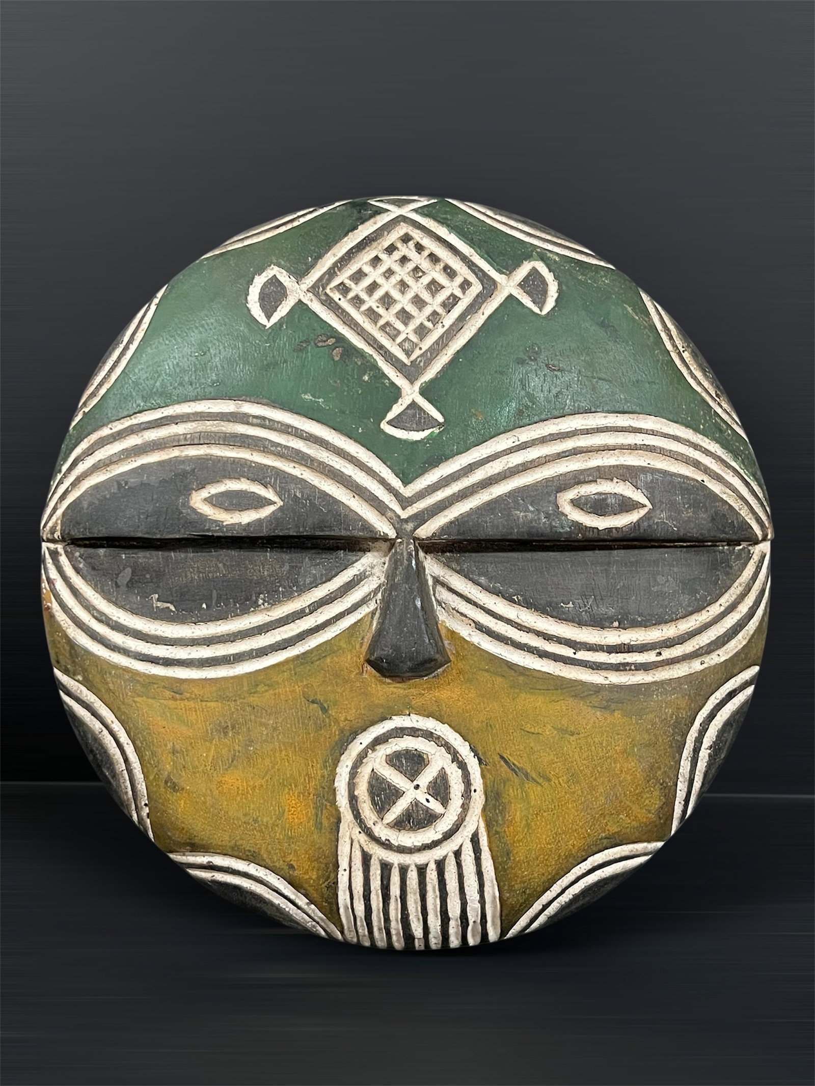 Carved Wood Teke Mask: African Tribal Art Carved Wood Teke Mask. The dimension is 11.75 inches high x 11.5 inches wide. Please be aware that some of the items are vintage, secondhand, old ages, antiques and may have a defec