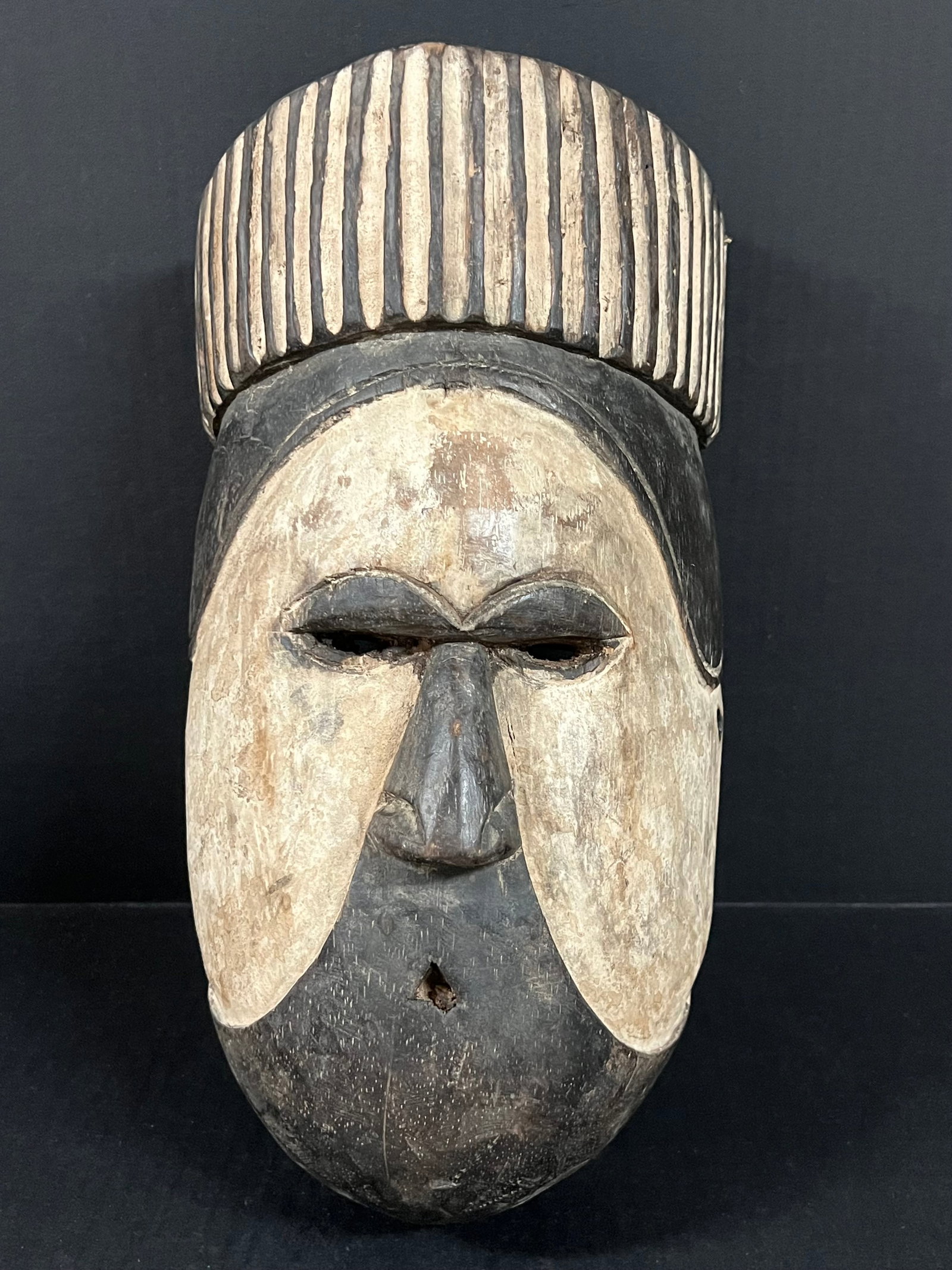 Carved Wood Fang Mask: African Tribal Art Carved Wood Fang Mask. The dimension is 15 inches high x 8.5 inches wide. Please be aware that some of the items are vintage, secondhand, old ages, antiques and may have a defects o