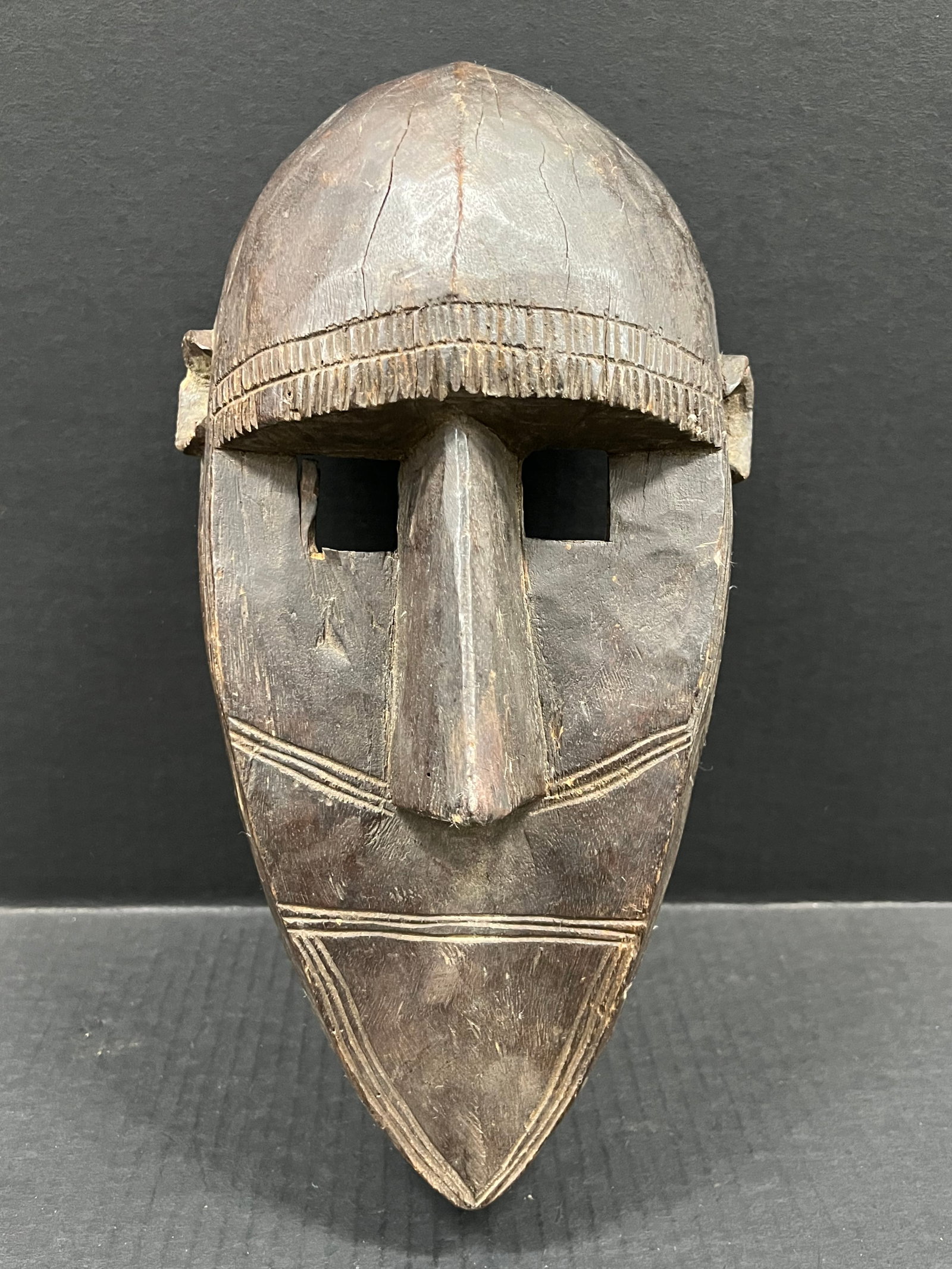 Carved Wood Bamana Mask: African Tribal Art Carved Wood Bamana Mask. The dimension is 13.5 inches high x 8 inches wide. Please be aware that some of the items are vintage, secondhand, old ages, antiques and may have a defects