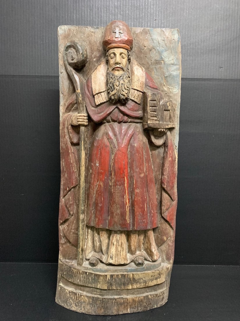 Carved Wood Saint Augustine Wall Plaque Sculpture: African Tribal Art Carved Wood Saint Augustine Wall Plaque Sculpture. The dimension is 27.5 inches high x 12 inches wide. Please be aware that some of the items are vintage, secondhand, old ages, anti