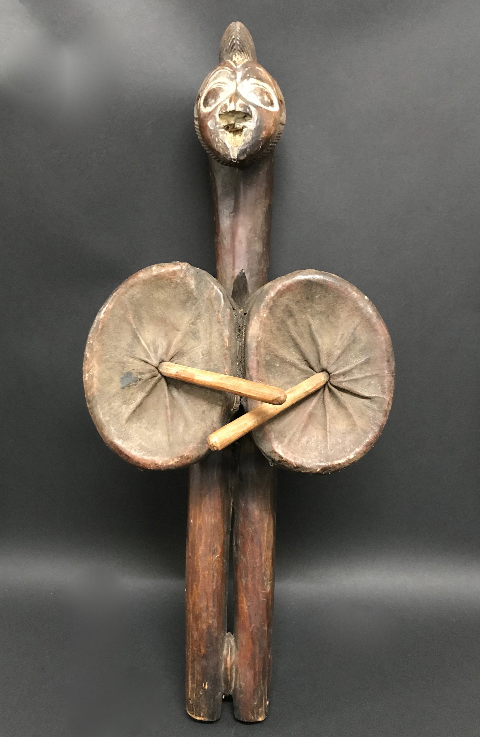Carved Wood Bello: African Tribal Art Carved Wood Bello. The dimension is 24 inches high x 10 inches wide. Please be aware that some of the items are vintage, secondhand, old ages, antiques and may have a defects or