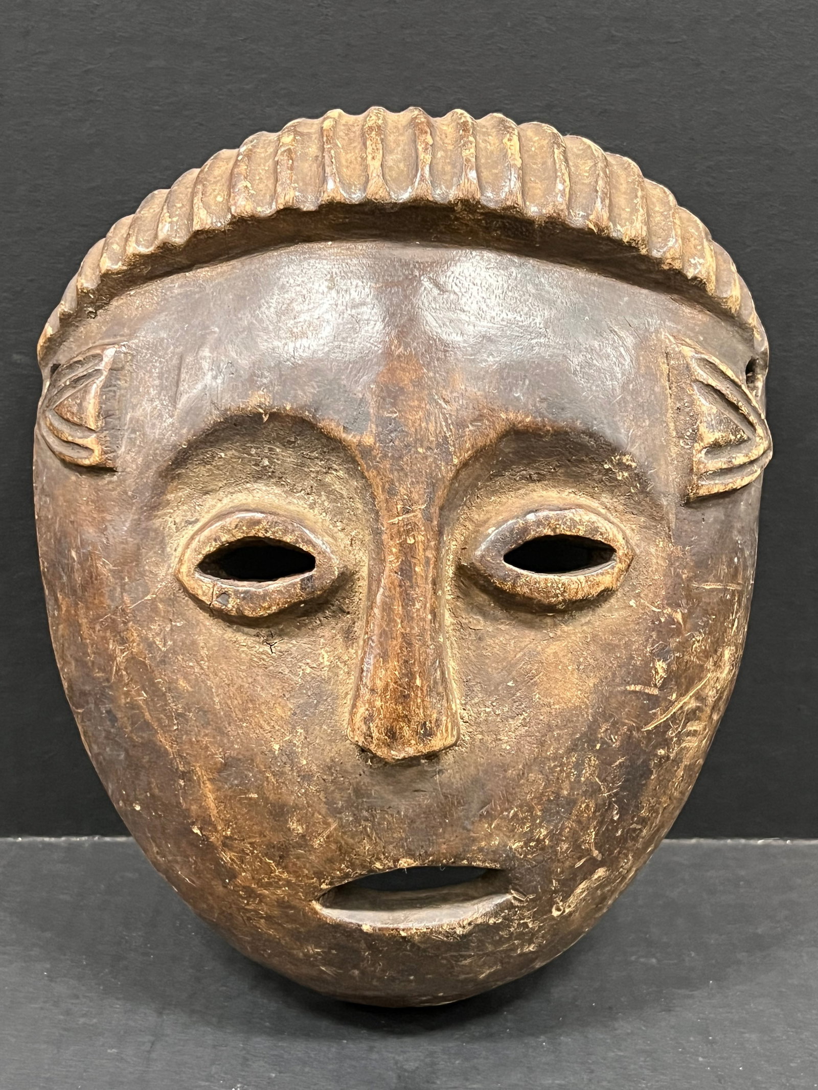 Carved Wood Tabwa Mask: African Tribal Art Carved Wood Tabwa Mask. The dimension is 9.5 inches high x 8 inches wide. Please be aware that some of the items are vintage, secondhand, old ages, antiques and may have a defects o