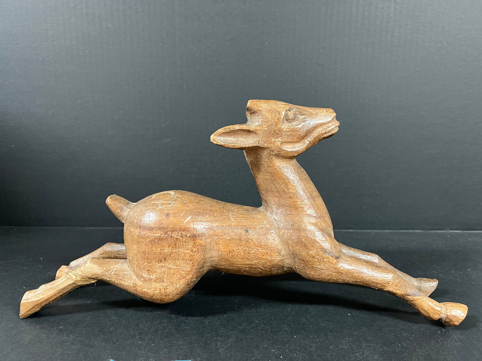 Folk Art Hand Carved Wooden Deer Sculpture: Vintage Folk Art Hand Carved Wooden Deer Home Decor Sculpture. The dimension is 7.25 inches high x 14.5 inches wide. Please be aware that some of the items are vintage, secondhand, old ages, antiques