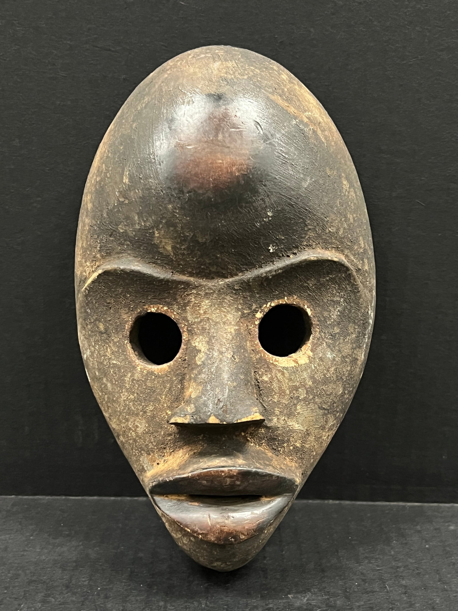 Carved Wood Dan Mask: African Tribal Art Carved Wood Dan Mask. The dimension is 9 inches high x 5 inches wide. Please be aware that some of the items are vintage, secondhand, old ages, antiques and may have a defects or si