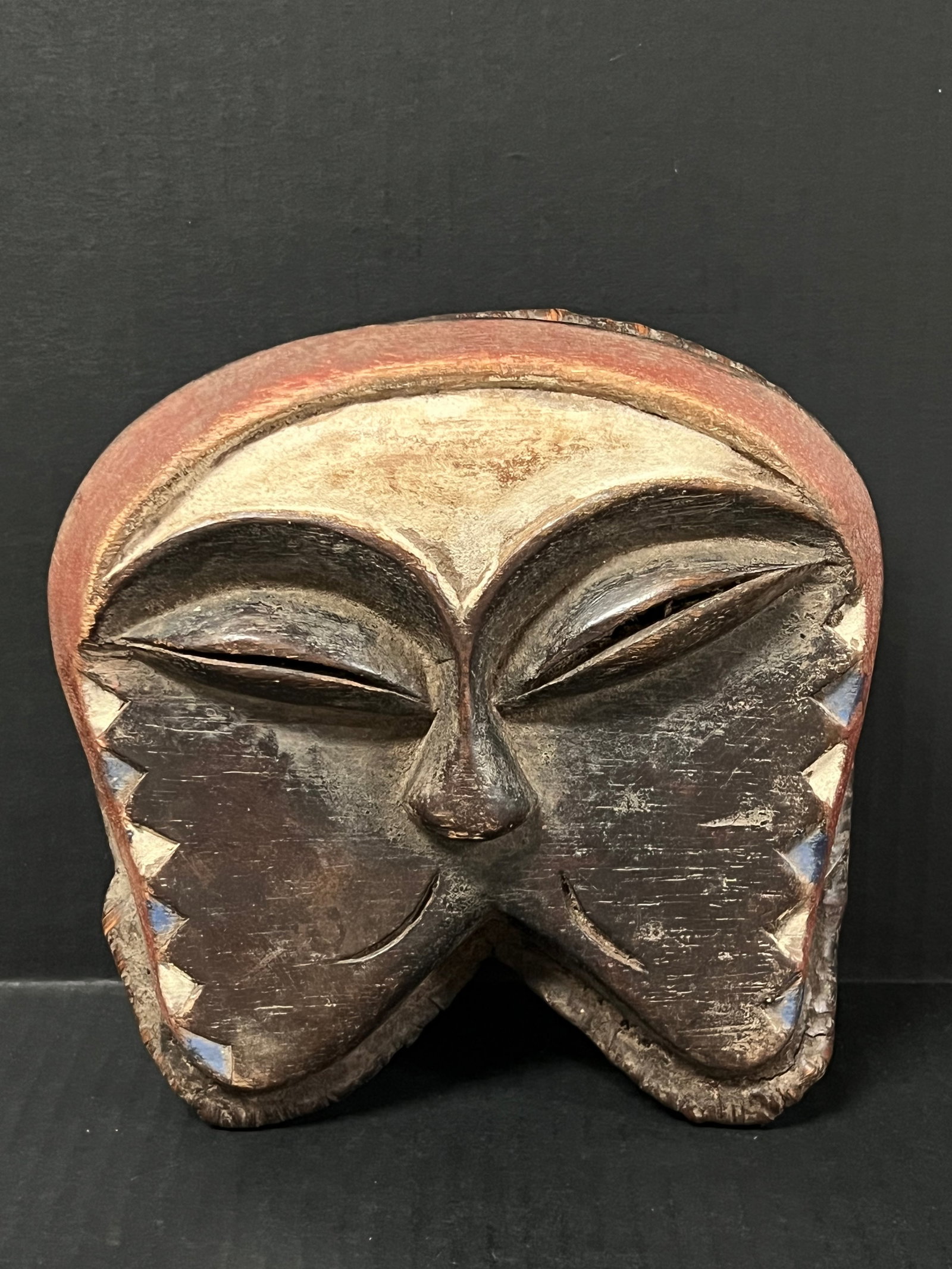 Carved Wood Kwele Mask: African Tribal Art Carved Wood Kwele Mask. The dimension is 7.25 inches high x 8 inches wide. Please be aware that some of the items are vintage, secondhand, old ages, antiques and may have a defects 