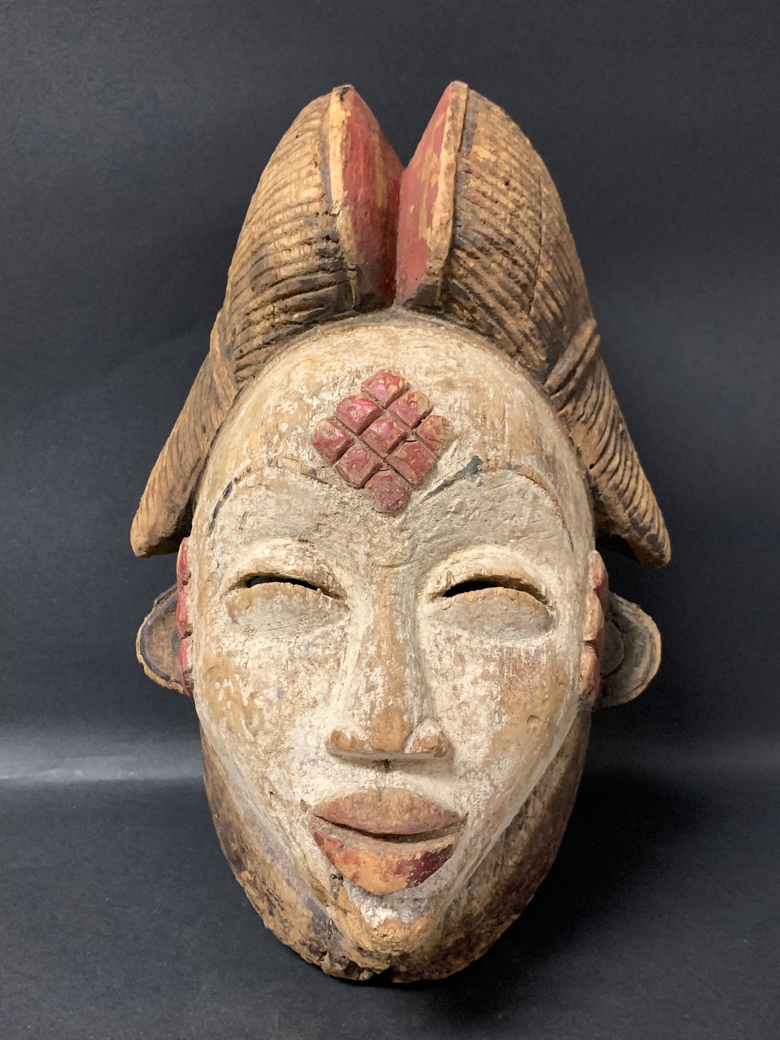 Carved Wood Punu Mask: African Tribal Art Carved Wood Punu Mask. The dimension is 14 inches high x 8 inches wide. Please be aware that some of the items are vintage, secondhand, old ages, antiques and may have a defects or 