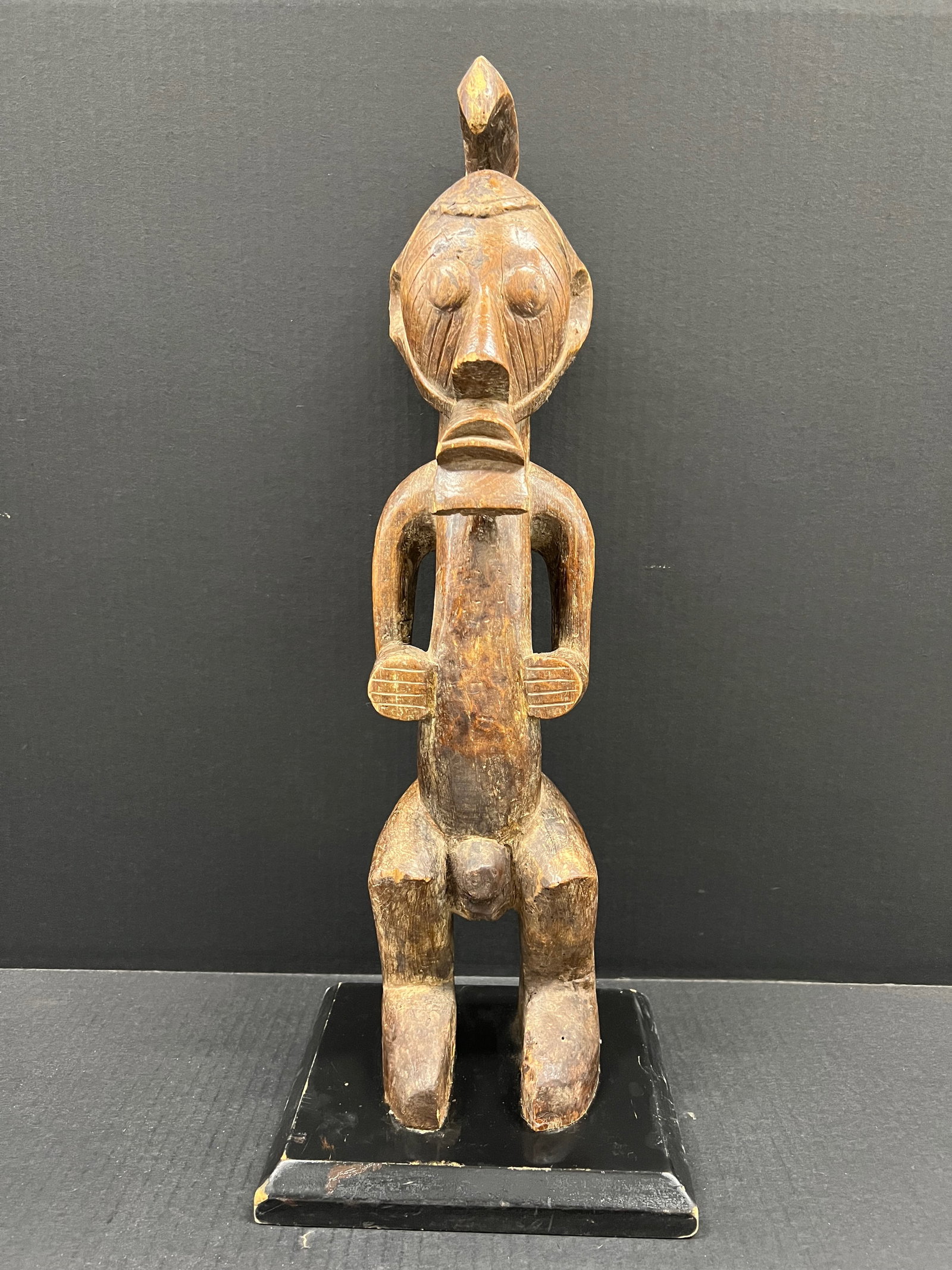Carved Wood Songye Statue: African Tribal Art Carved Wood Songye Statue. The dimension is 21 inches high x 4.75 inches wide. Please be aware that some of the items are vintage, secondhand, old ages, antiques and may have a defe