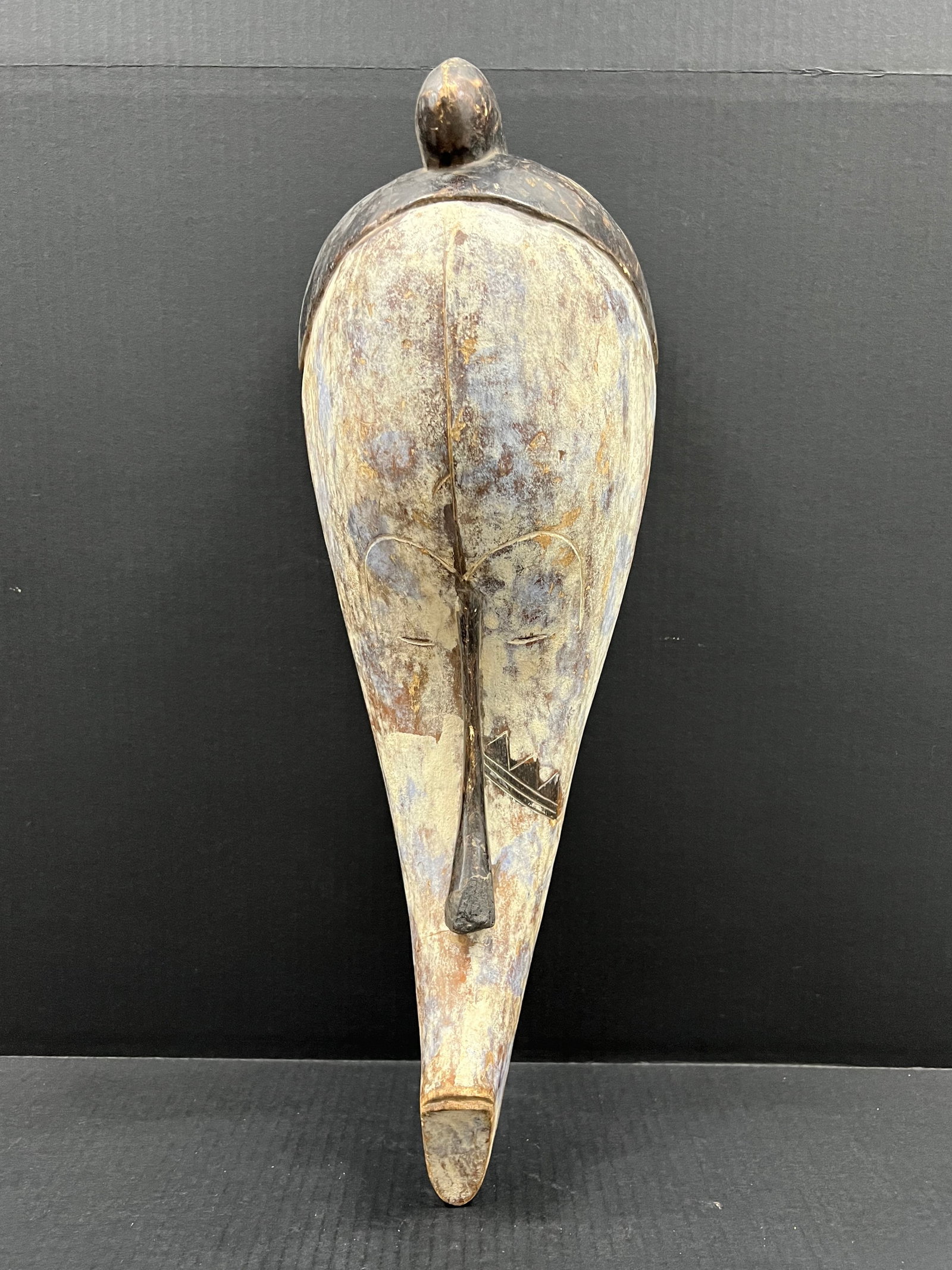 Carved Wood Fang Mask: African Tribal Art Carved Wood Fang Mask. The dimension is 22 inches high x 8.5 inches wide. Please be aware that some of the items are vintage, secondhand, old ages, antiques and may have a defects o