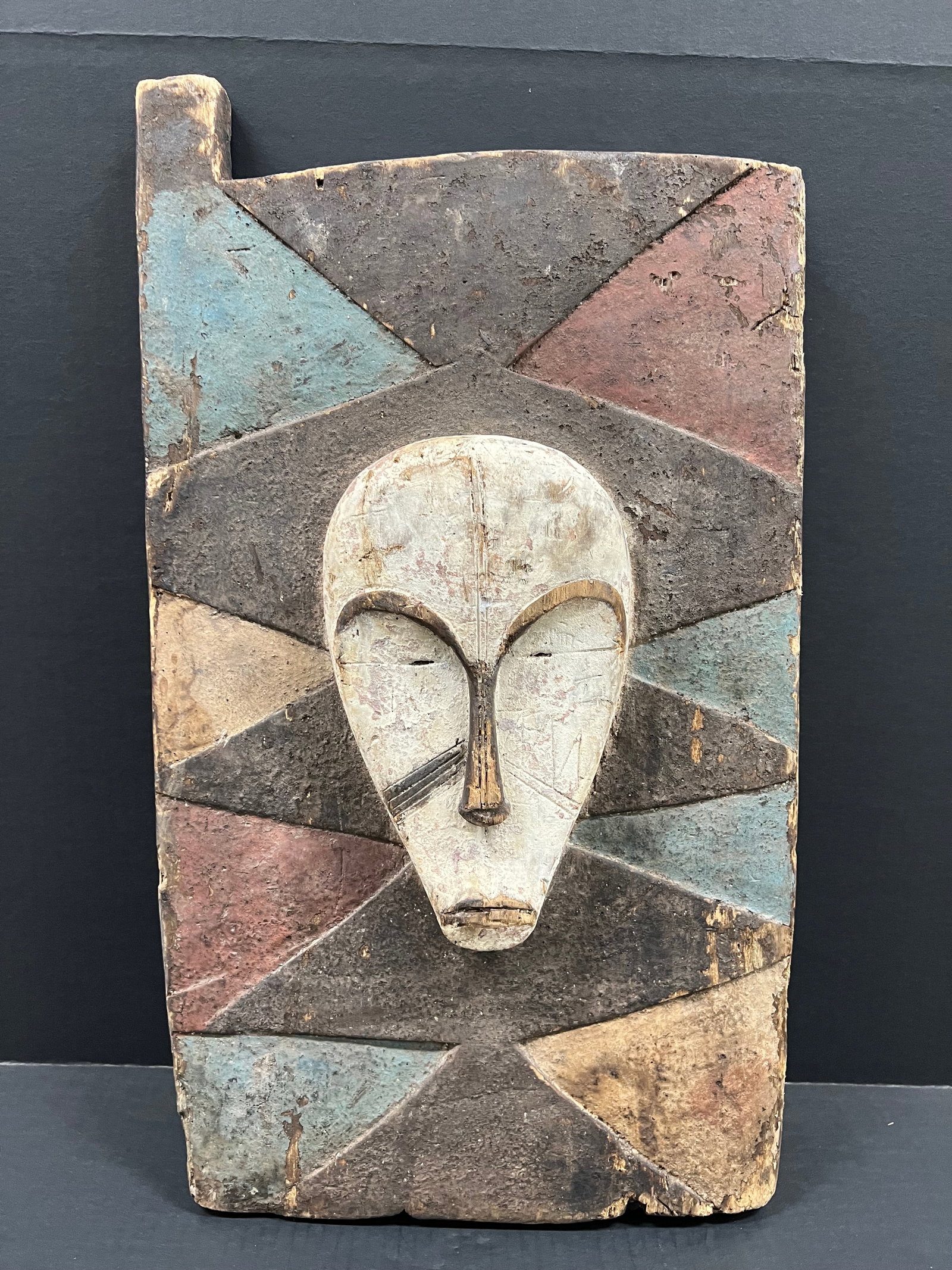 Carved Wood Fang Door: African Tribal Art Carved Wood Fang Door. The dimension is 14 inches high x 23 inches wide. Please be aware that some of the items are vintage, secondhand, old ages, antiques and may have a defects or