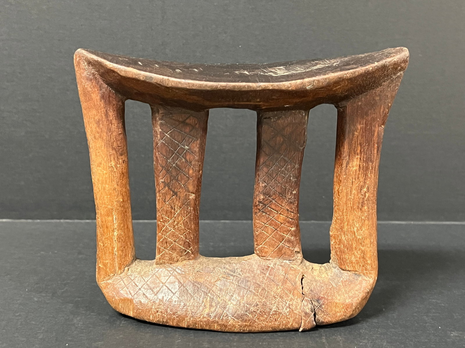 Carved Wood Ethiopian Headrest: African Tribal Art Carved Wood Ethiopian Headrest. The dimension is 5.5 inches high x 7 inches wide. Please be aware that some of the items are vintage, secondhand, old ages, antiques and may have a d