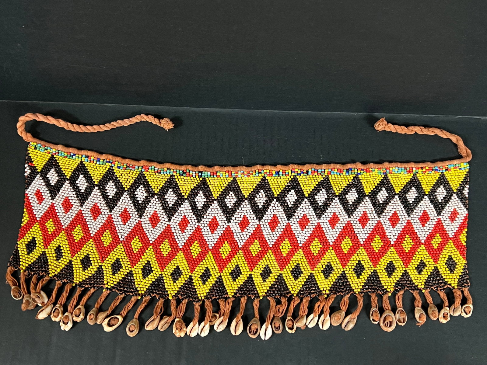 Ceremonial Skirt Kirdi Beaded Cache: African Tribal Art Ceremonial Skirt Kirdi Beaded Cache. The dimension is 8 inches high x 19 inches wide. Please be aware that some of the items are vintage, secondhand, old ages, antiques and may have