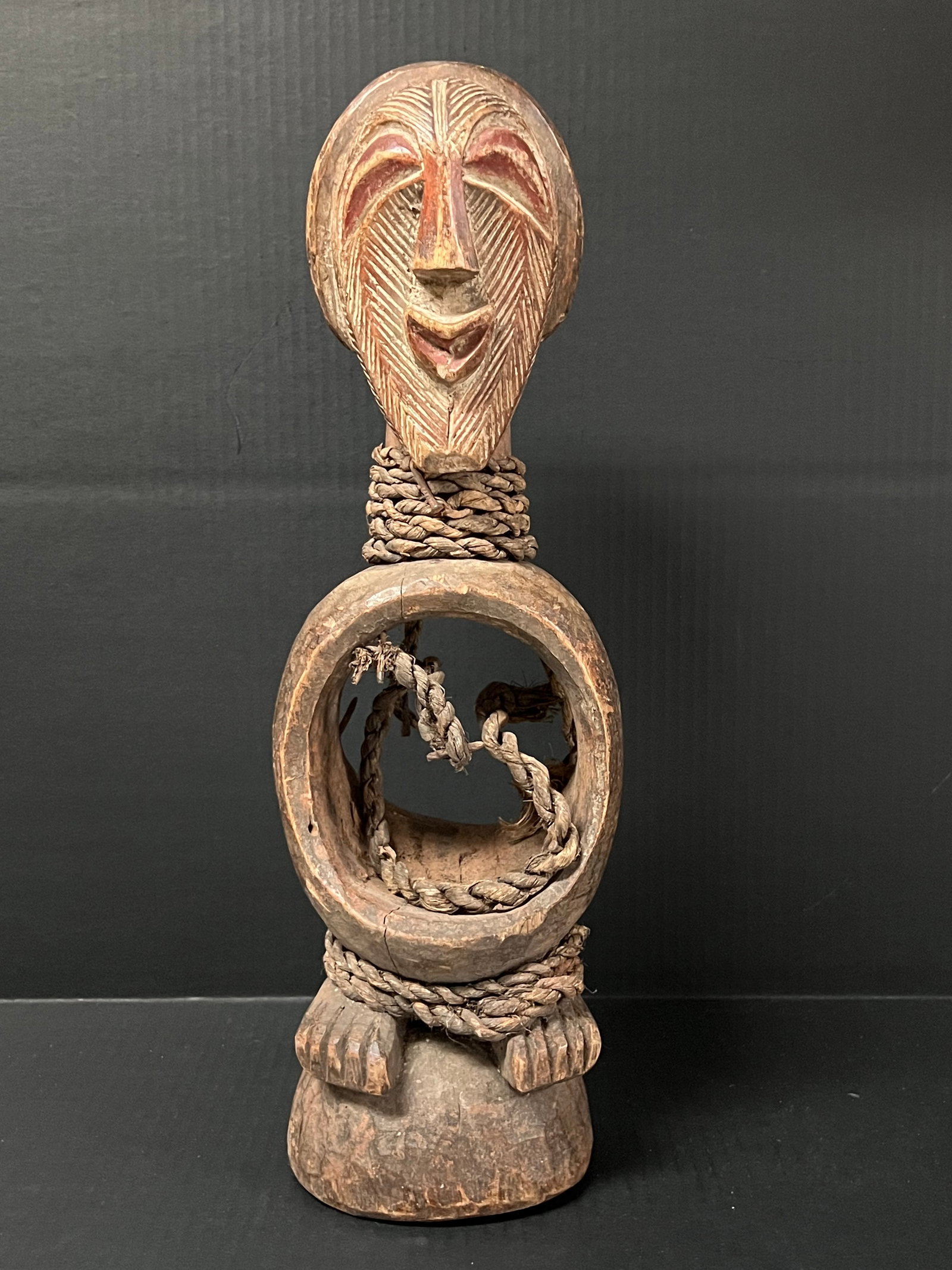 Carved Wood Songye Statue: African Tribal Art Carved Wood Songye Statue. The dimension is 16.5 inches high x 6.5 inches wide. Please be aware that some of the items are vintage, secondhand, old ages, antiques and may have a