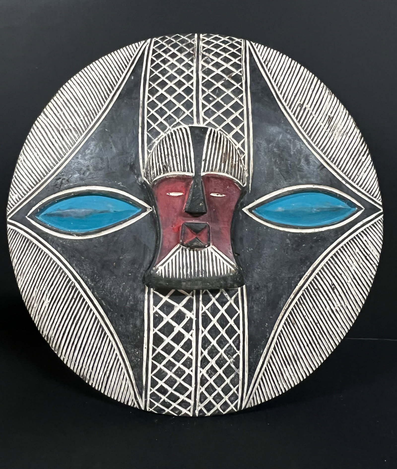 Carved Wood Fang Mask: African Tribal Art Carved Wood Fang Mask. The dimension is 22.5 inches high x 22 inches wide. Please be aware that some of the items are vintage, secondhand, old ages, antiques and may have a defects 