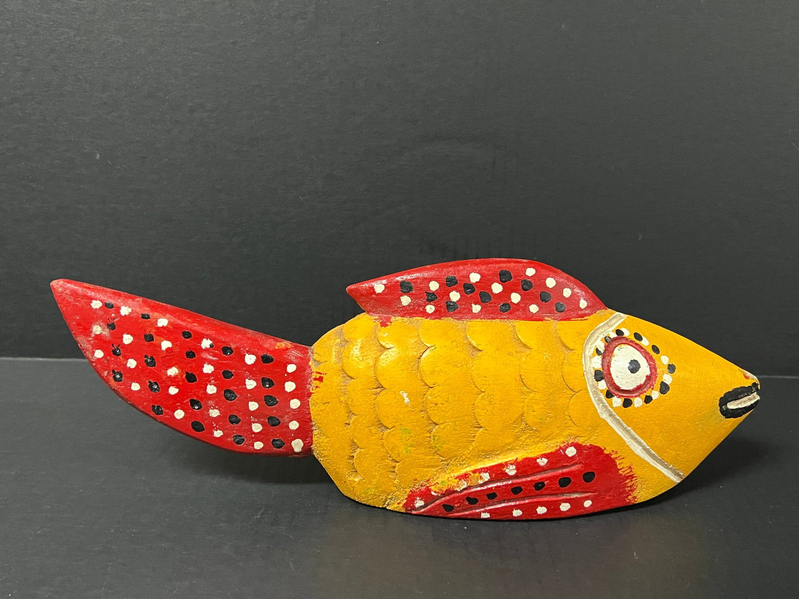 Carved Wood Bozo Puppet Fish Sculpture: African Tribal Art Carved Wood Bozo Puppet Fish Sculpture. The dimension is 5 inches high x 13.5 inches wide. Please be aware that some of the items are vintage, secondhand, old ages, antiques and may